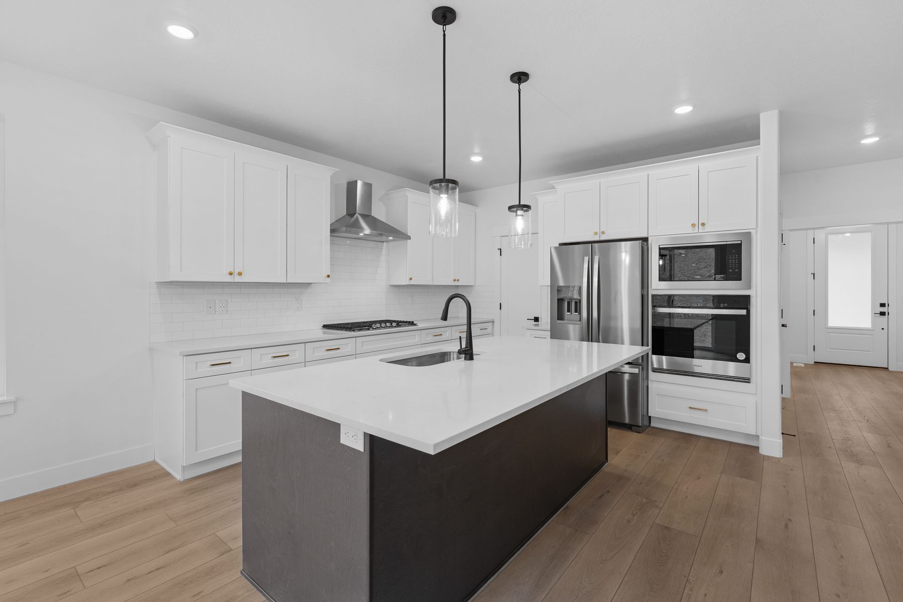 The kitchen has beautiful white wood cabinetry.