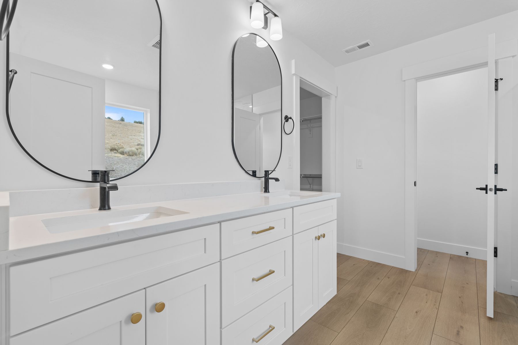 The master bathroom has a sprawling, dual-sink vanity.