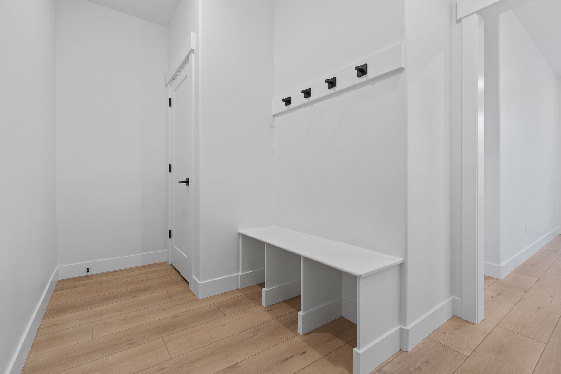 The mudroom provides a great drop zone with hooks, a bench, and storage.