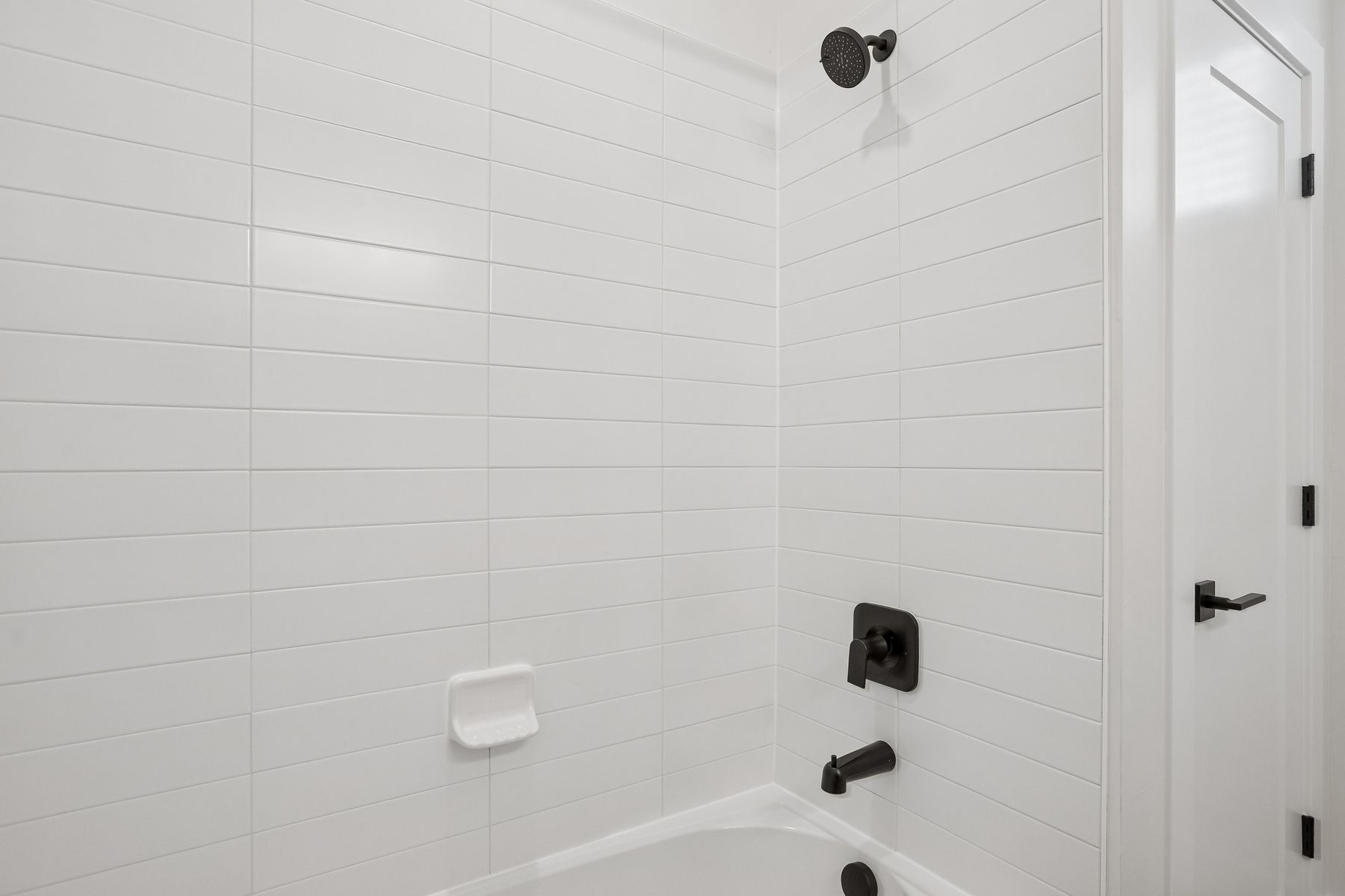The secondary bathroom has a beautiful shower-tub combo.