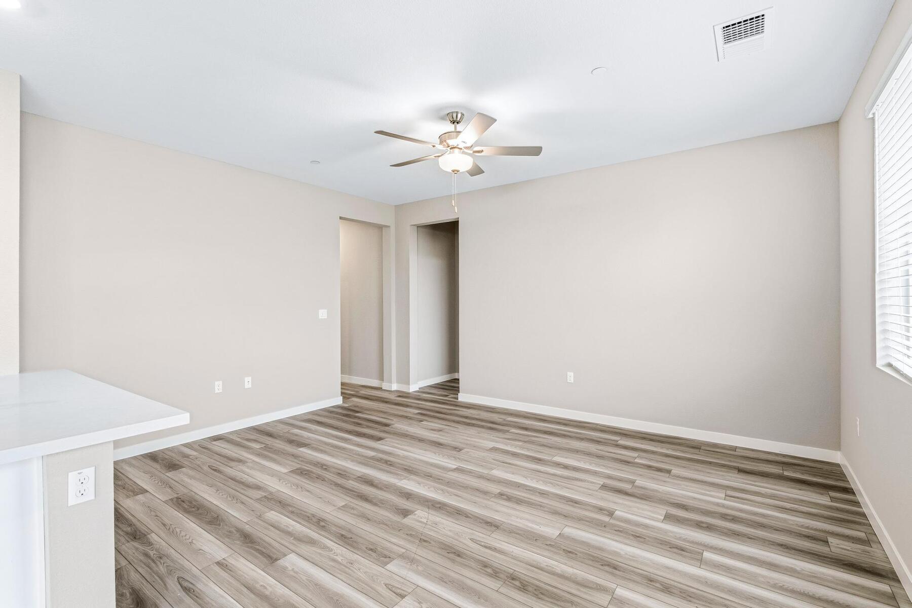 The family room is spacious with a ceiling fan.