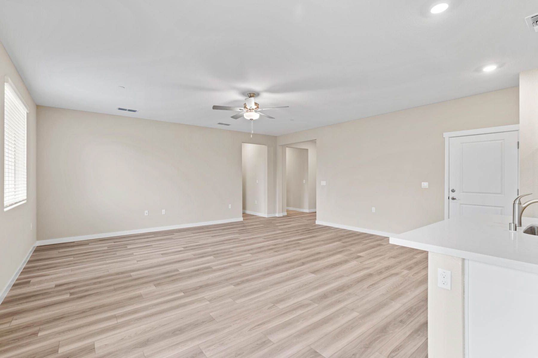 The family room is spacious with a ceiling fan.