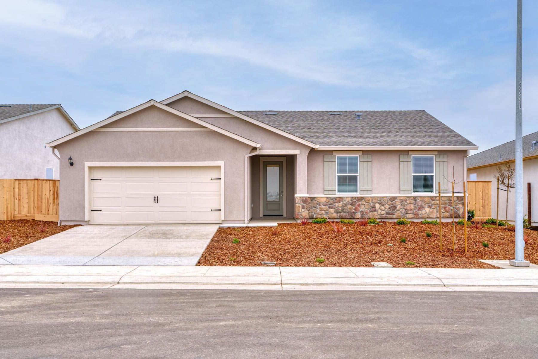 The Colfax is a beautiful single story home with stone and stuccoi.
