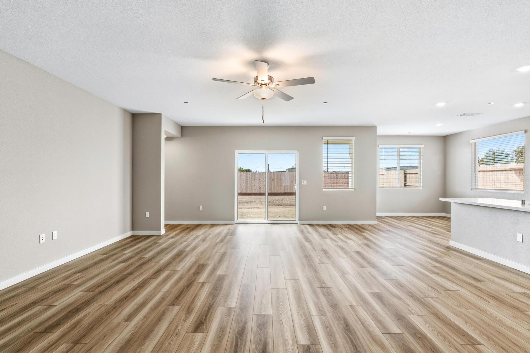 The family room is spacious with a ceiling fan.