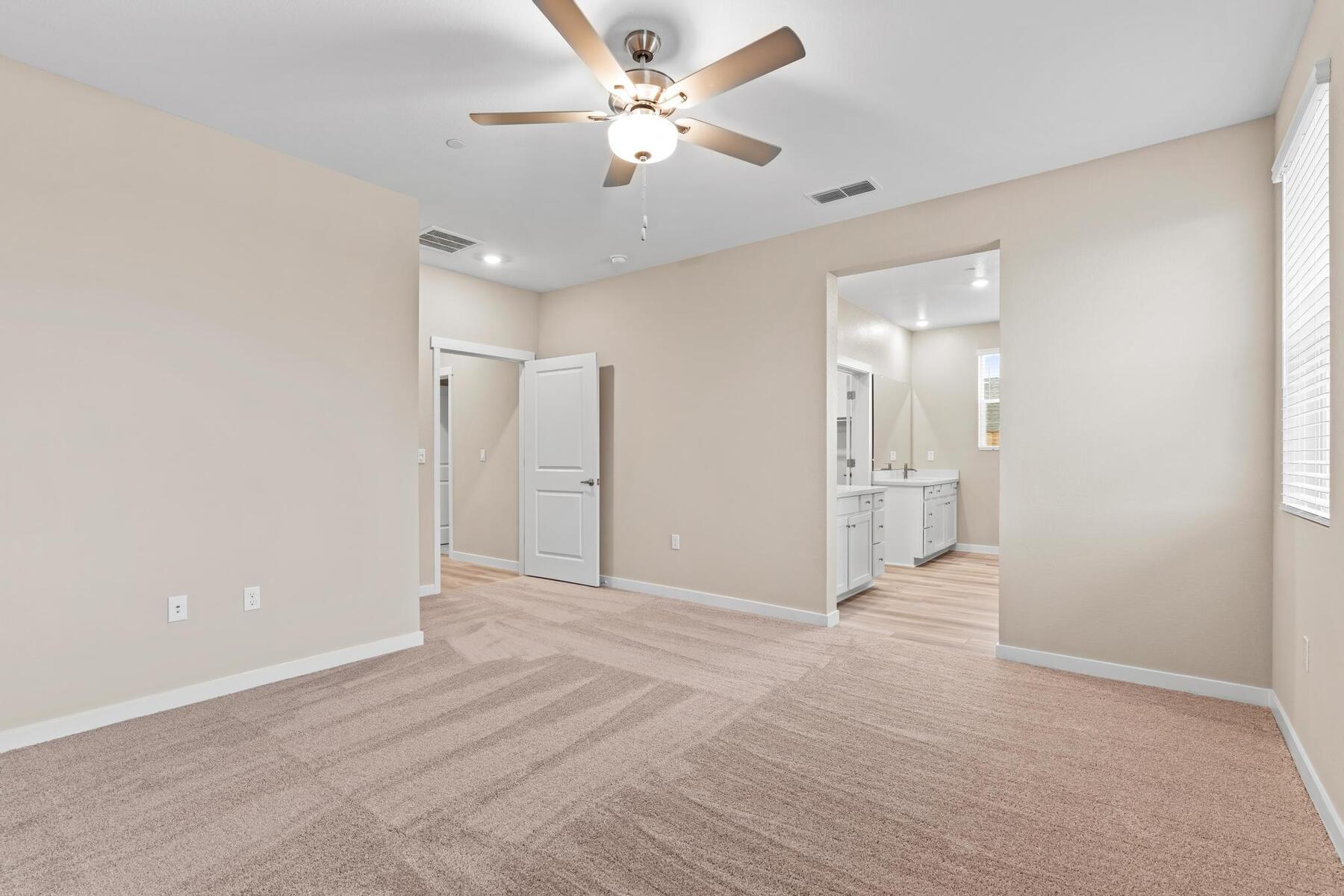 The master bedroom is spacious with large windows.