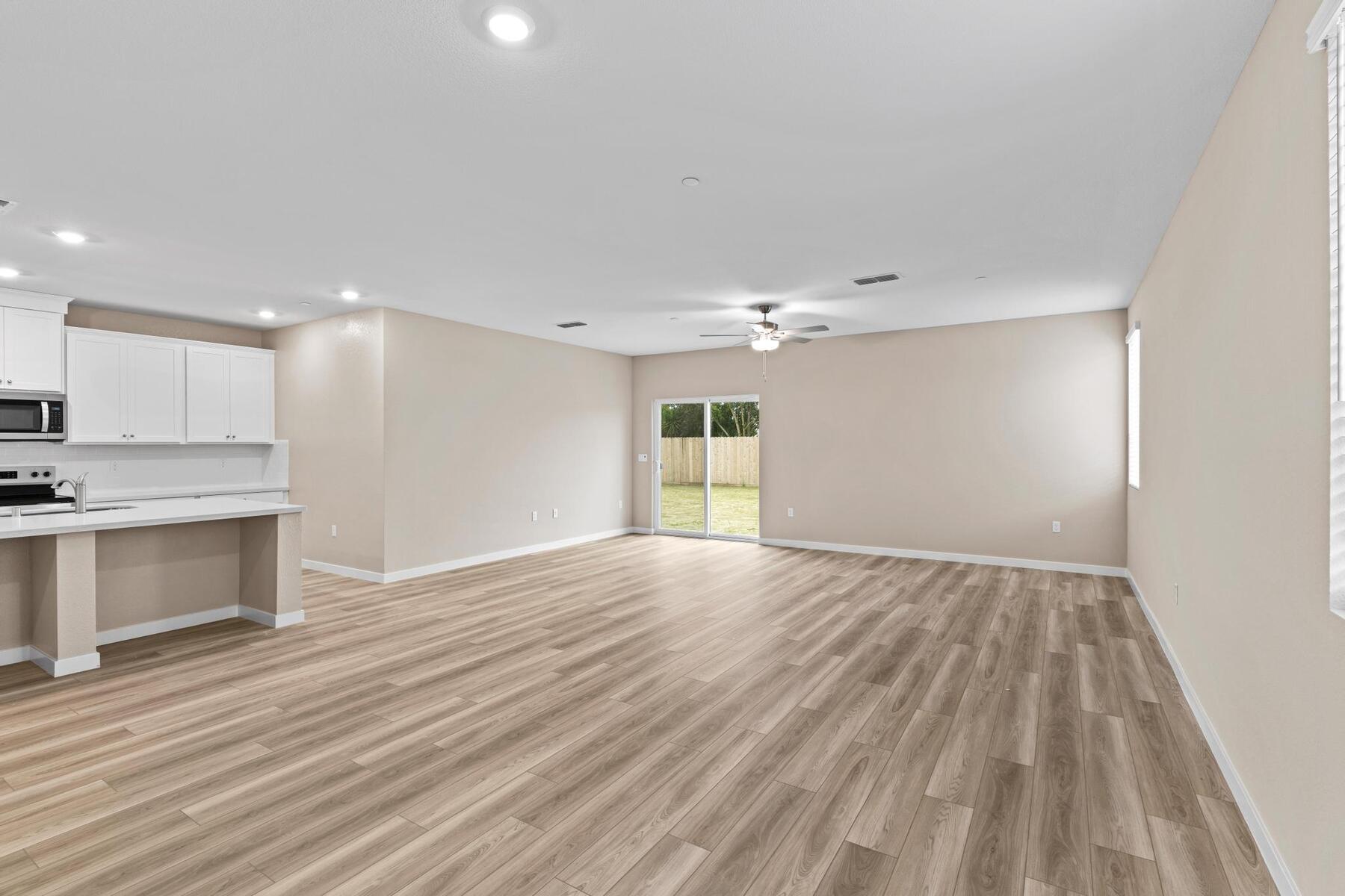 The family room is spacious with a ceiling fan.