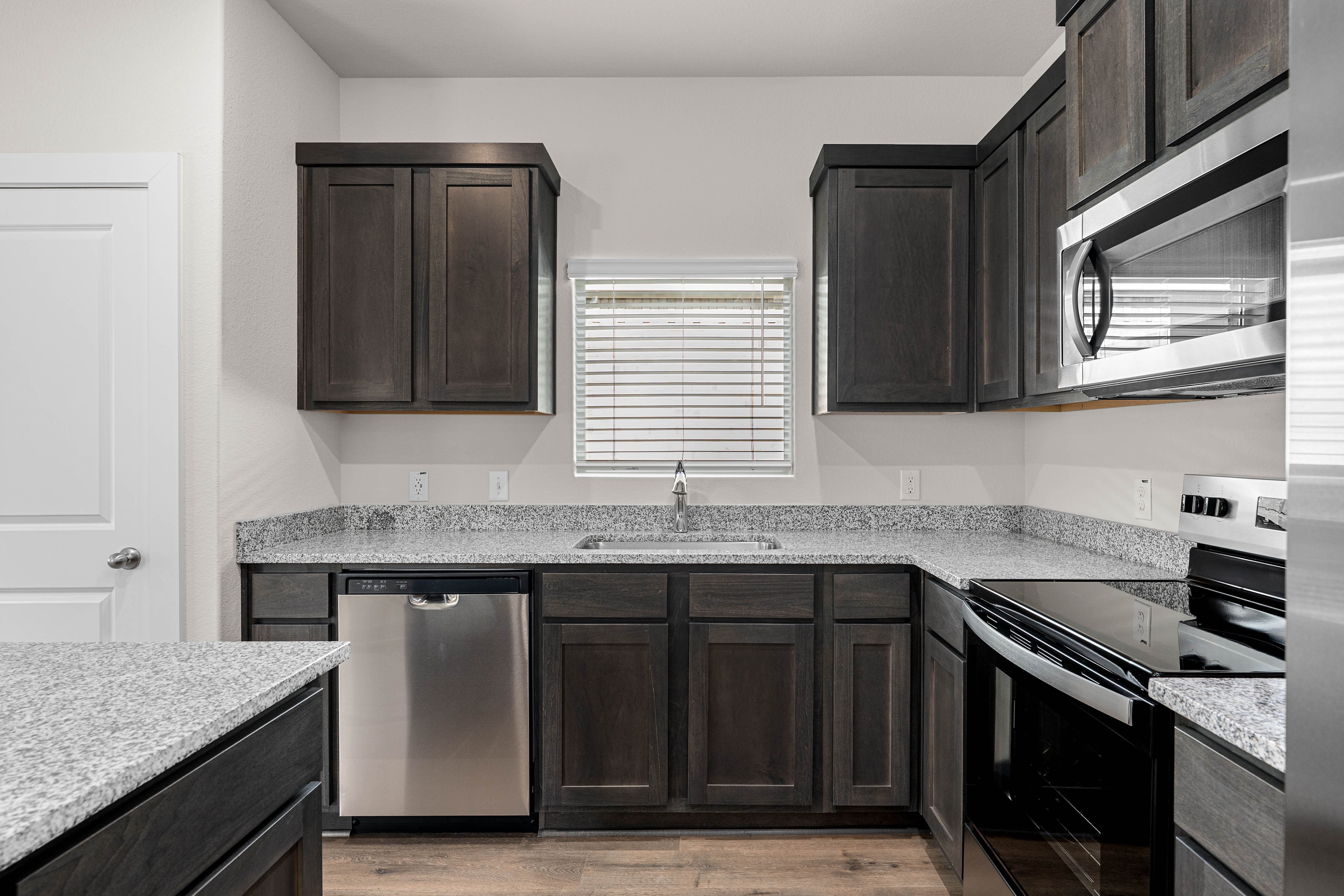 The kitchen has sprawling granite countertops.