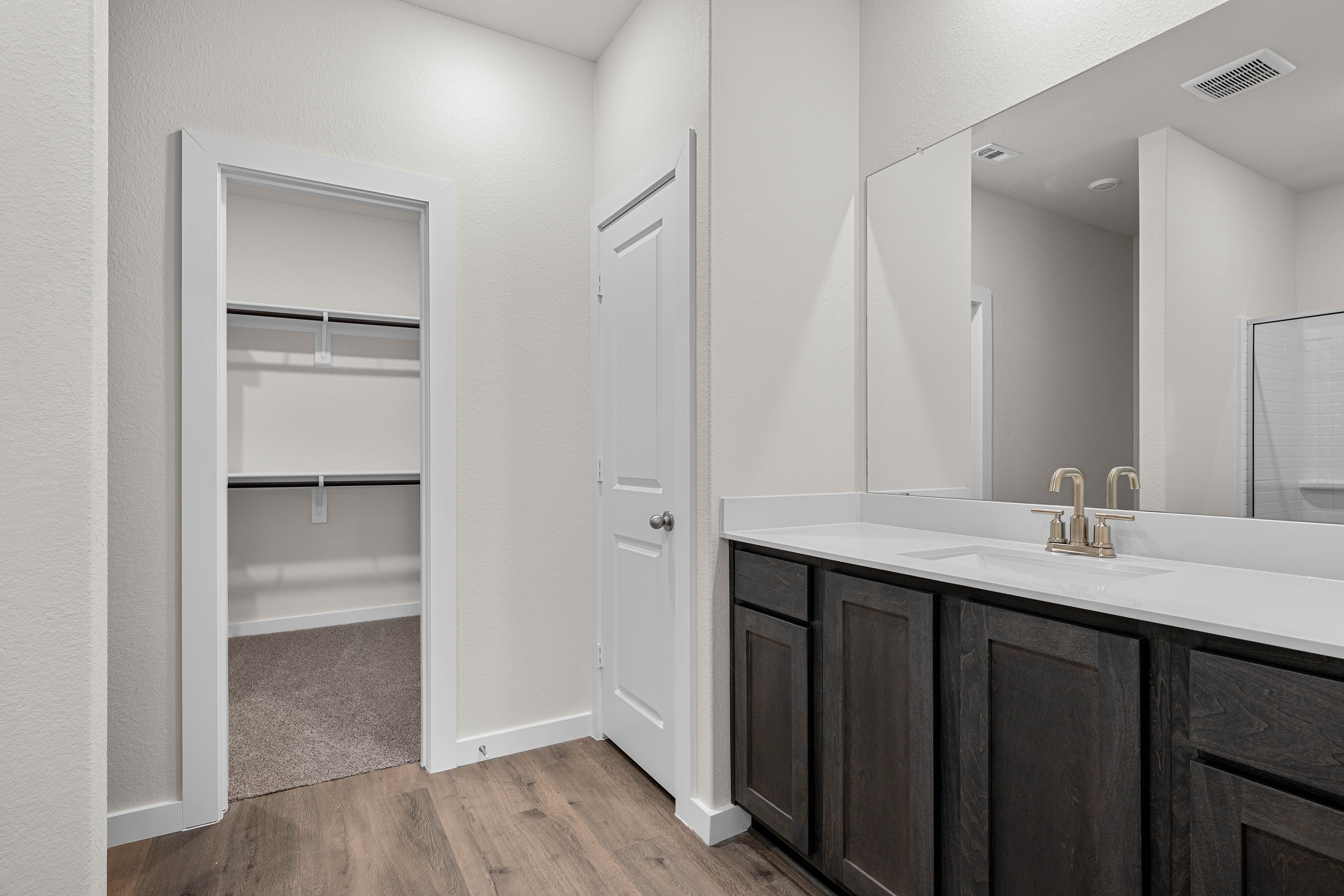 The master bathroom has a sprawling vanity.