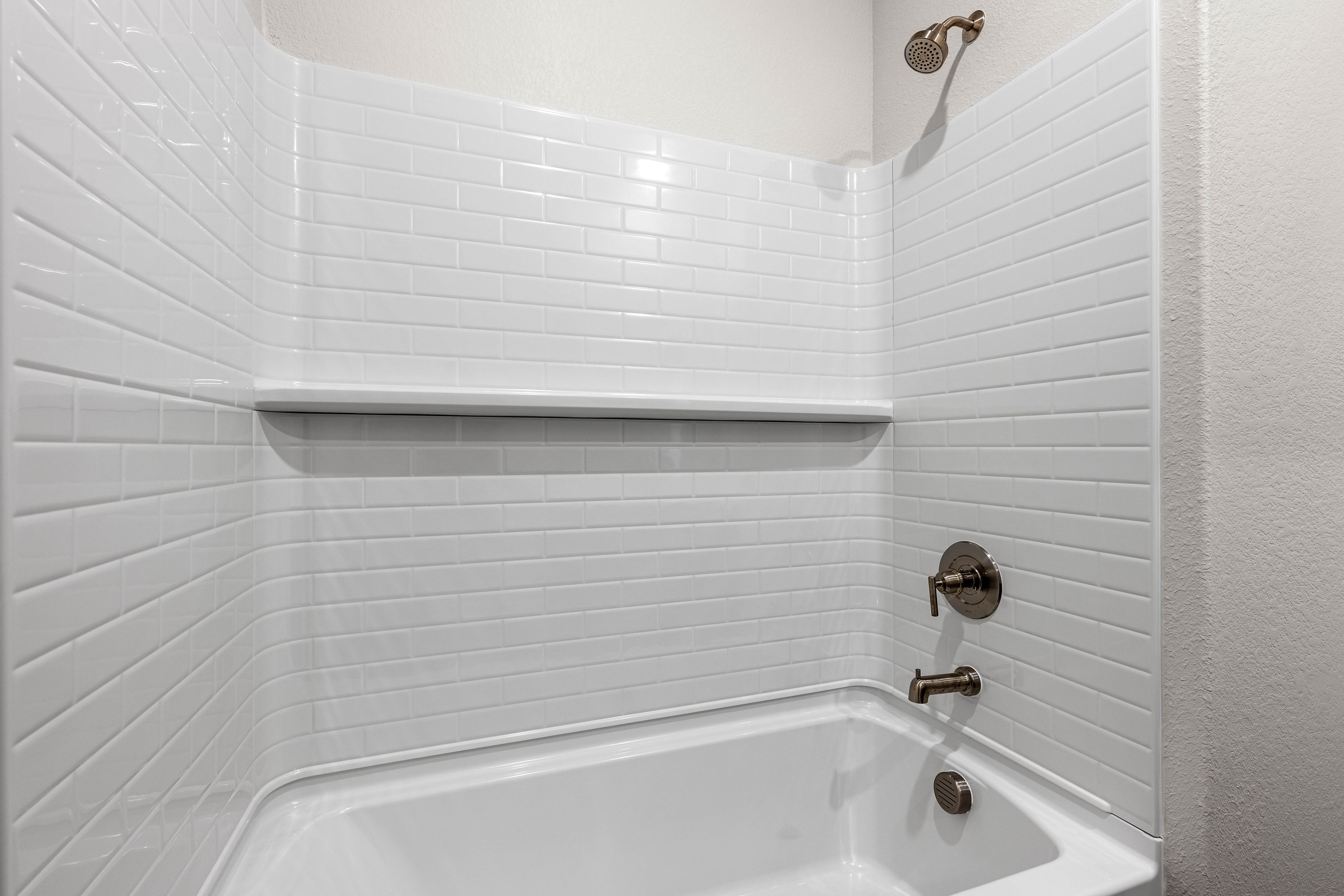 The secondary bathroom has a shower-tub combo.