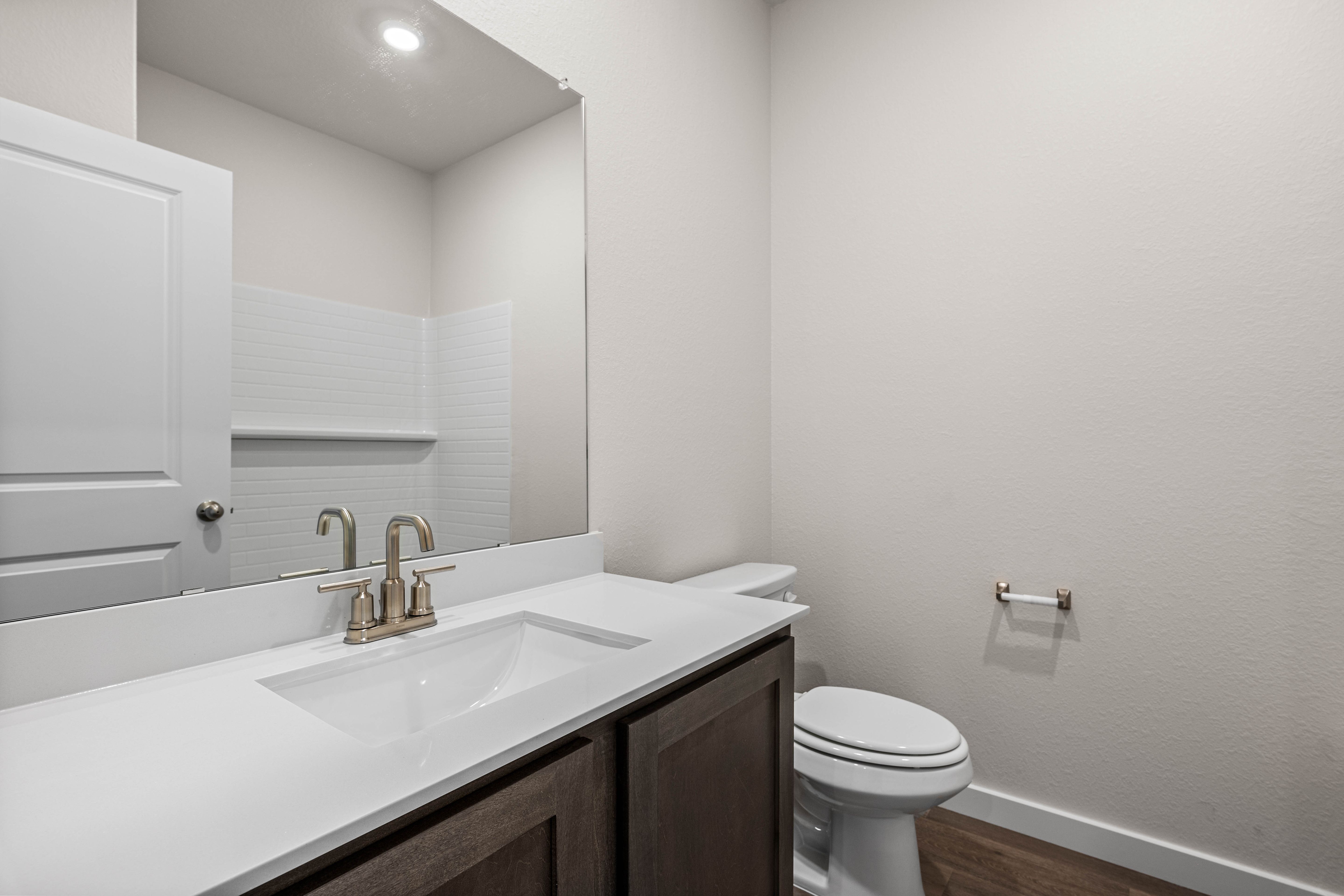 The secondary bathroom has a sprawling vanity space.