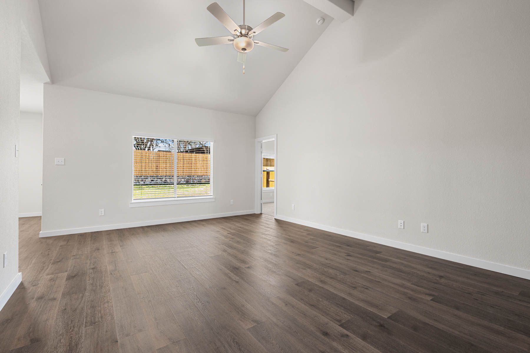 The living room has a large window that lets in great, natural light.