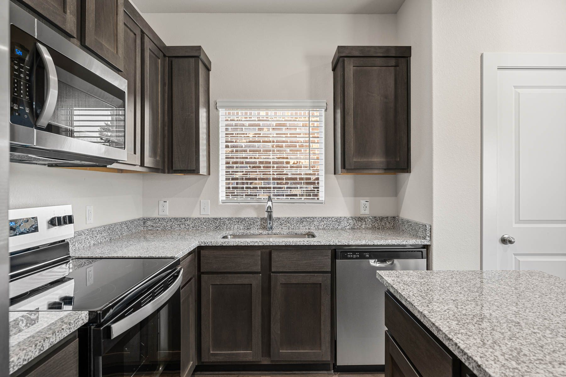 The kitchen has sprawling granite countertops.