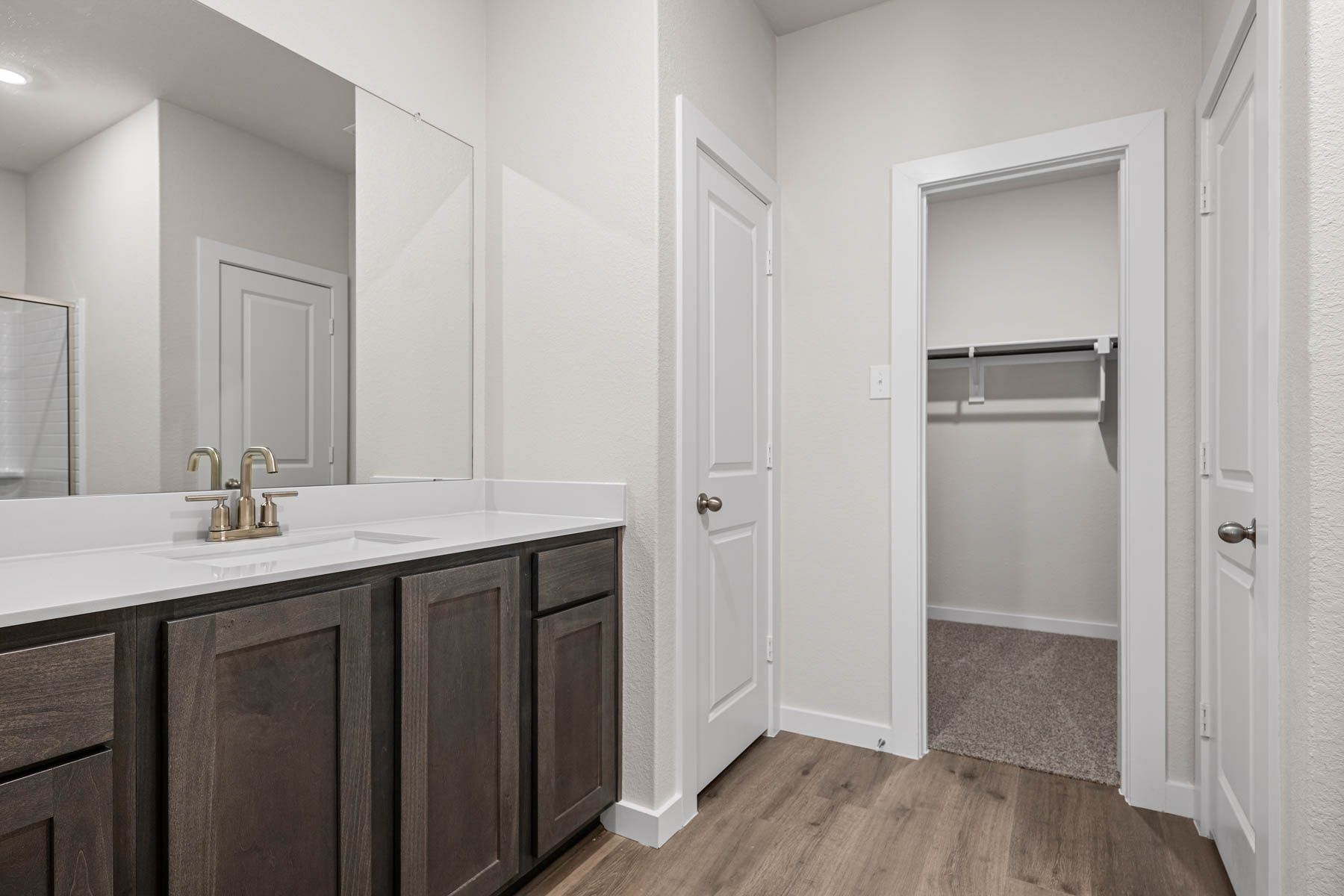 The master bathroom has a sprawling vanity.