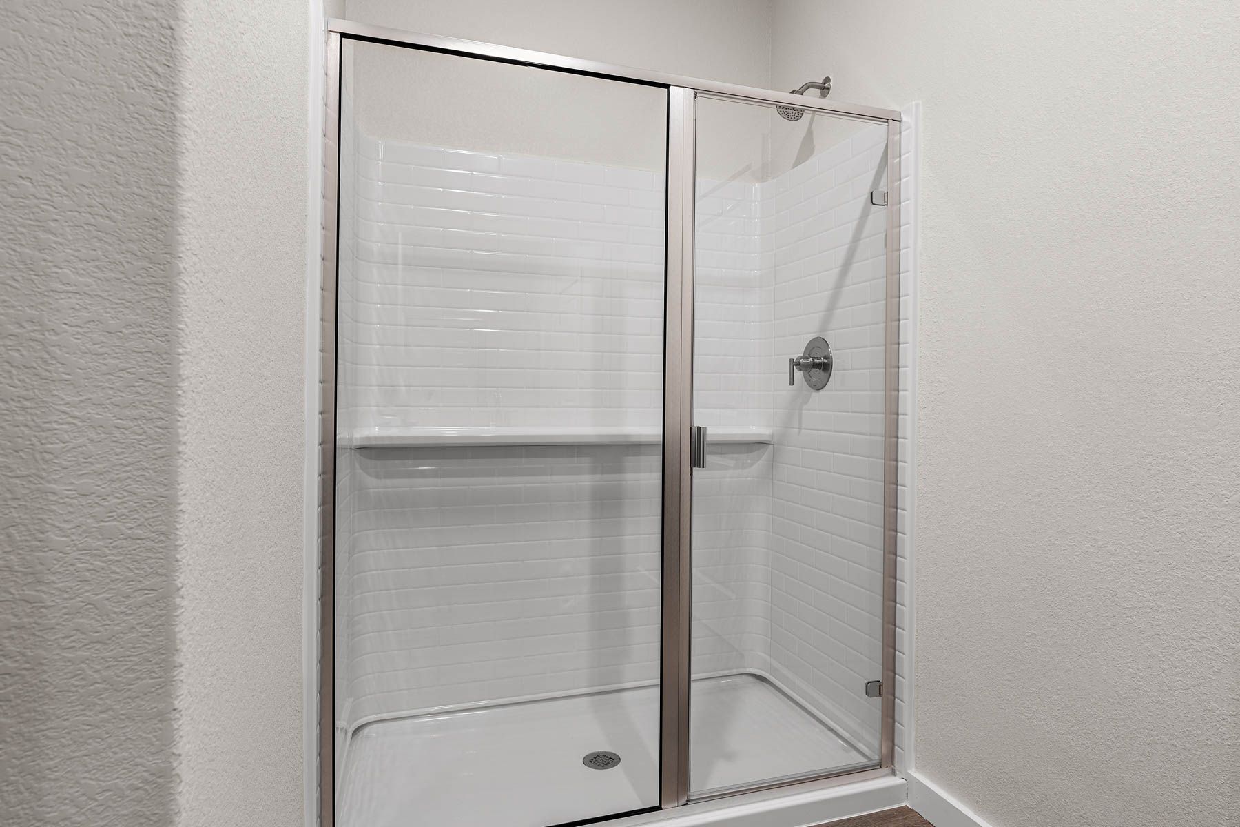 The master bathroom has a glass, walk-in shower.