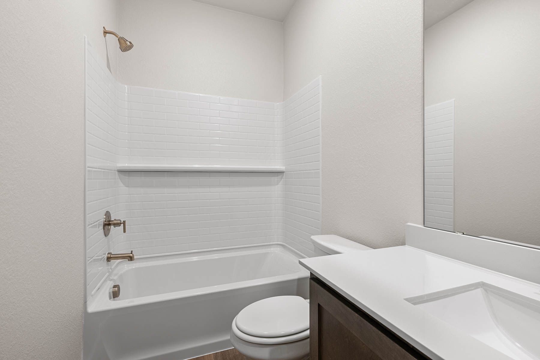 The secondary bathroom has a shower-tub combo.