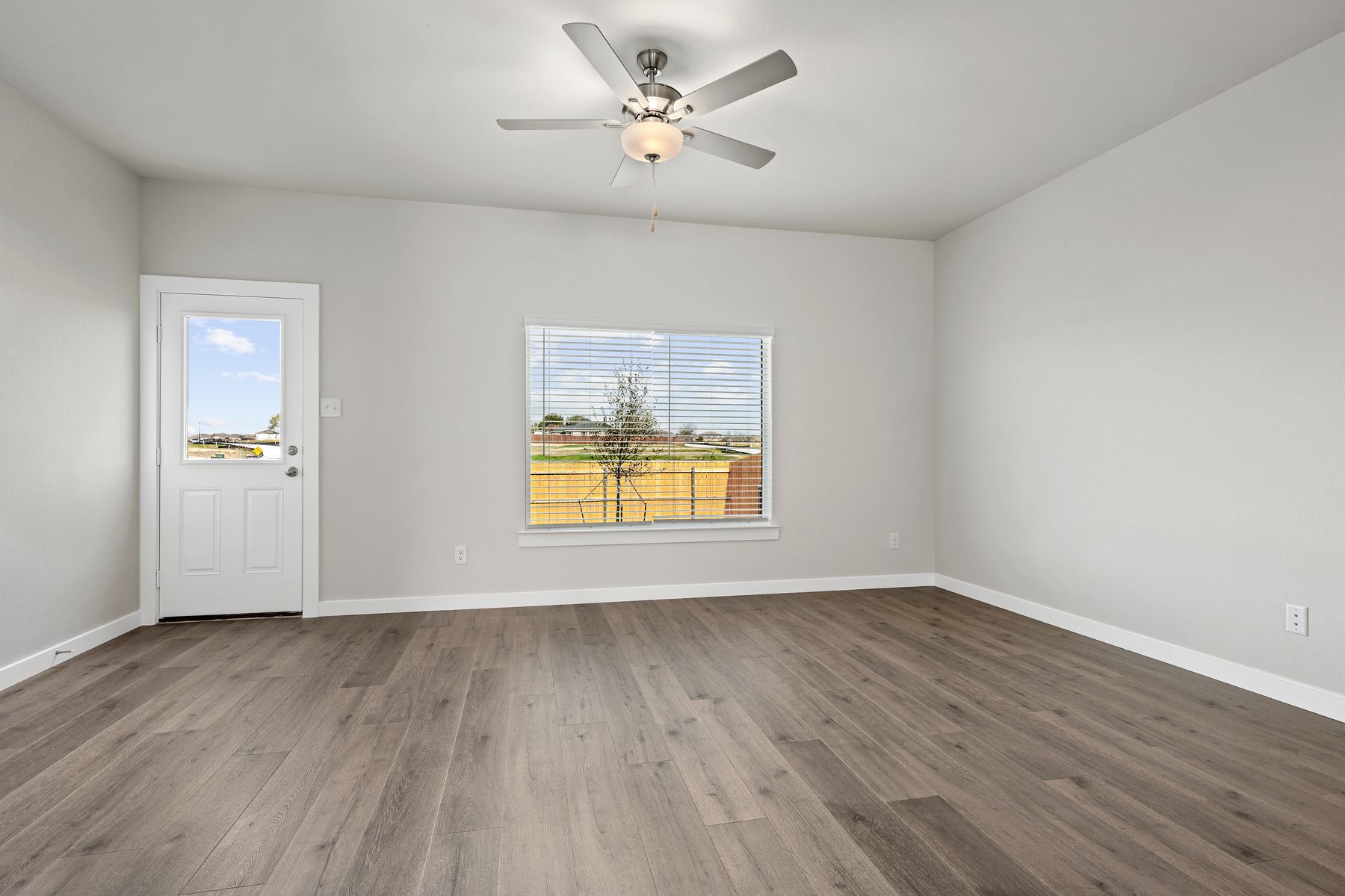 The living room has a large window that lets in great, natural light.