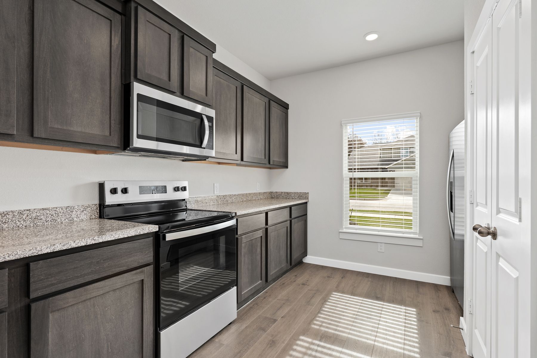 The kitchen has beautiful wood cabinetry.