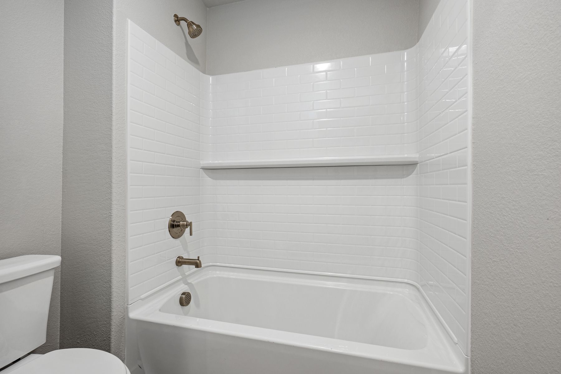 The secondary bathroom has a shower-tub combo.