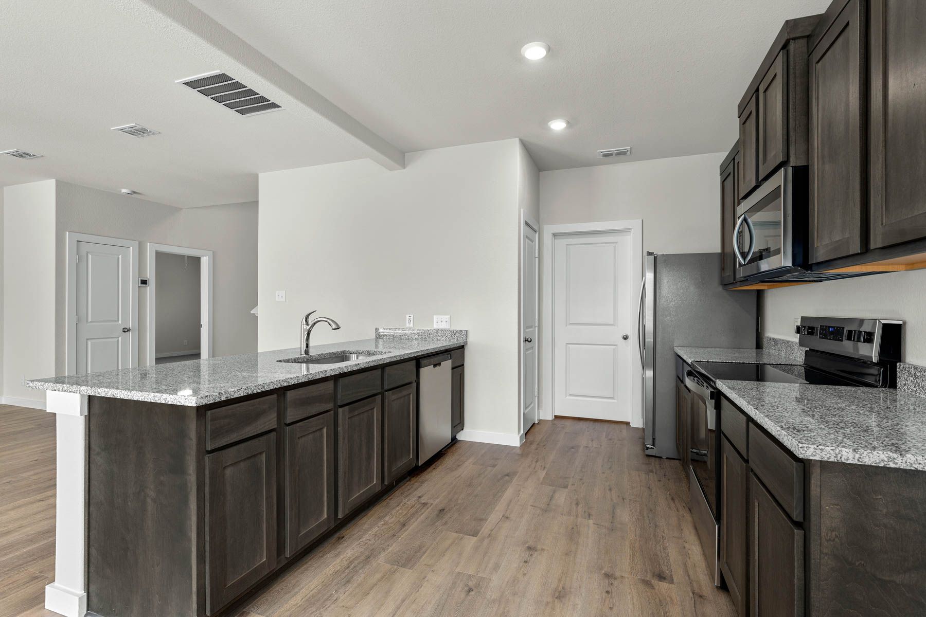 The kitchen has beautiful wood cabinetry.