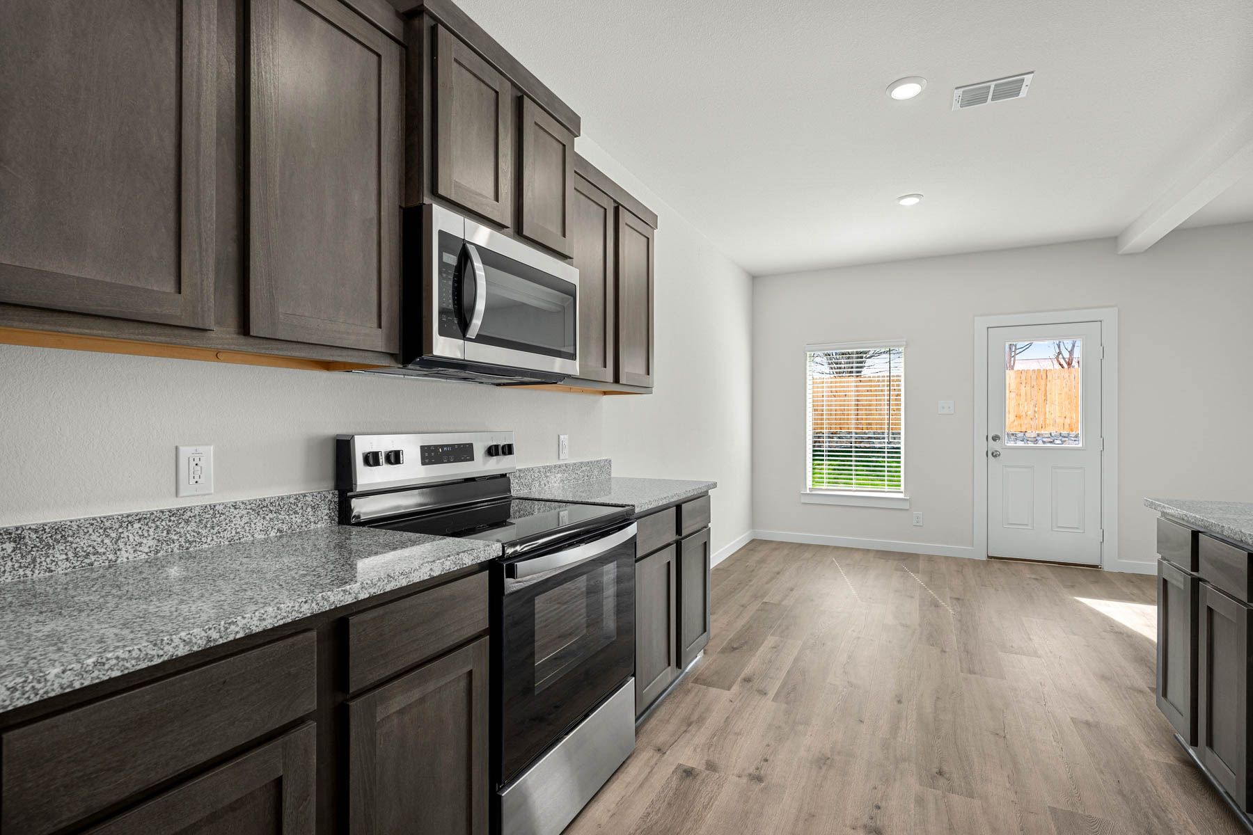 The kitchen has sprawling granite countertops.