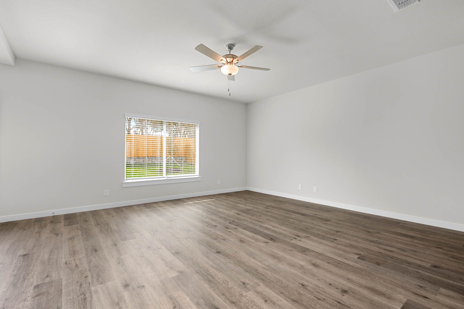 The living room has a large window that lets in great, natural light.