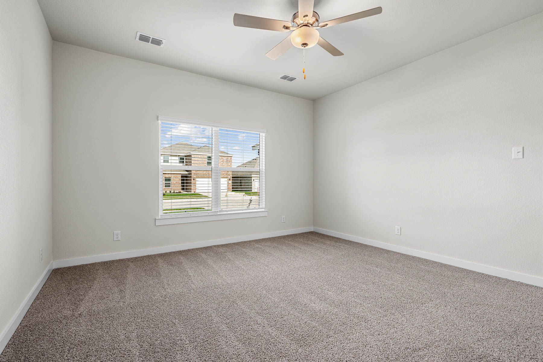The spacious master bedroom has a window that lets in great, natural light and backyard views.