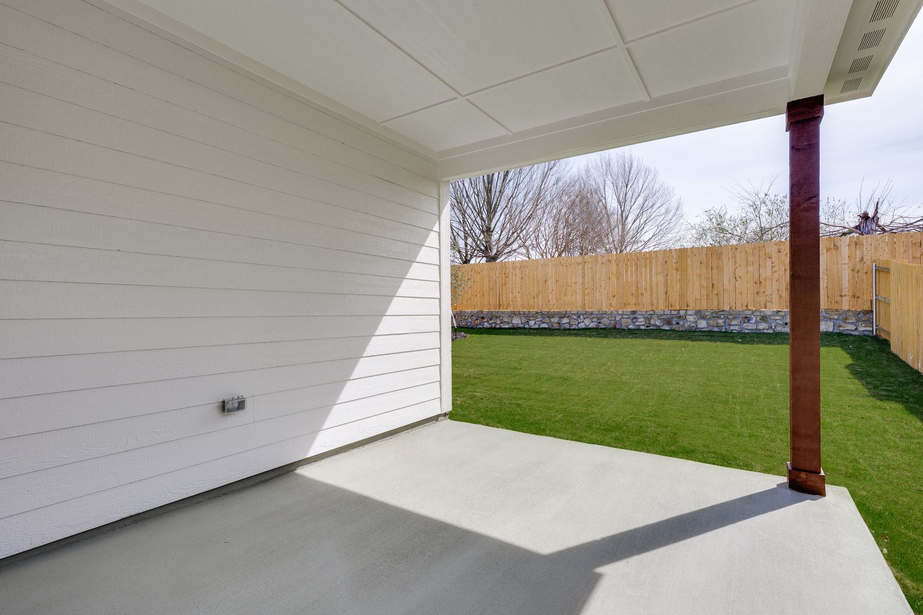The covered back patio provides a wonderful space for outdoor living. 