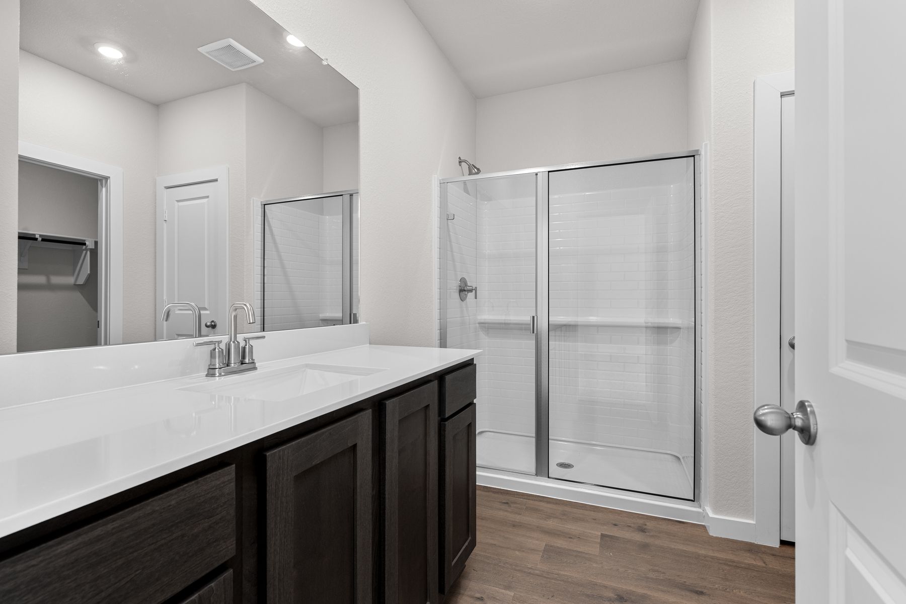 The master bathroom has a glass, walk-in shower.
