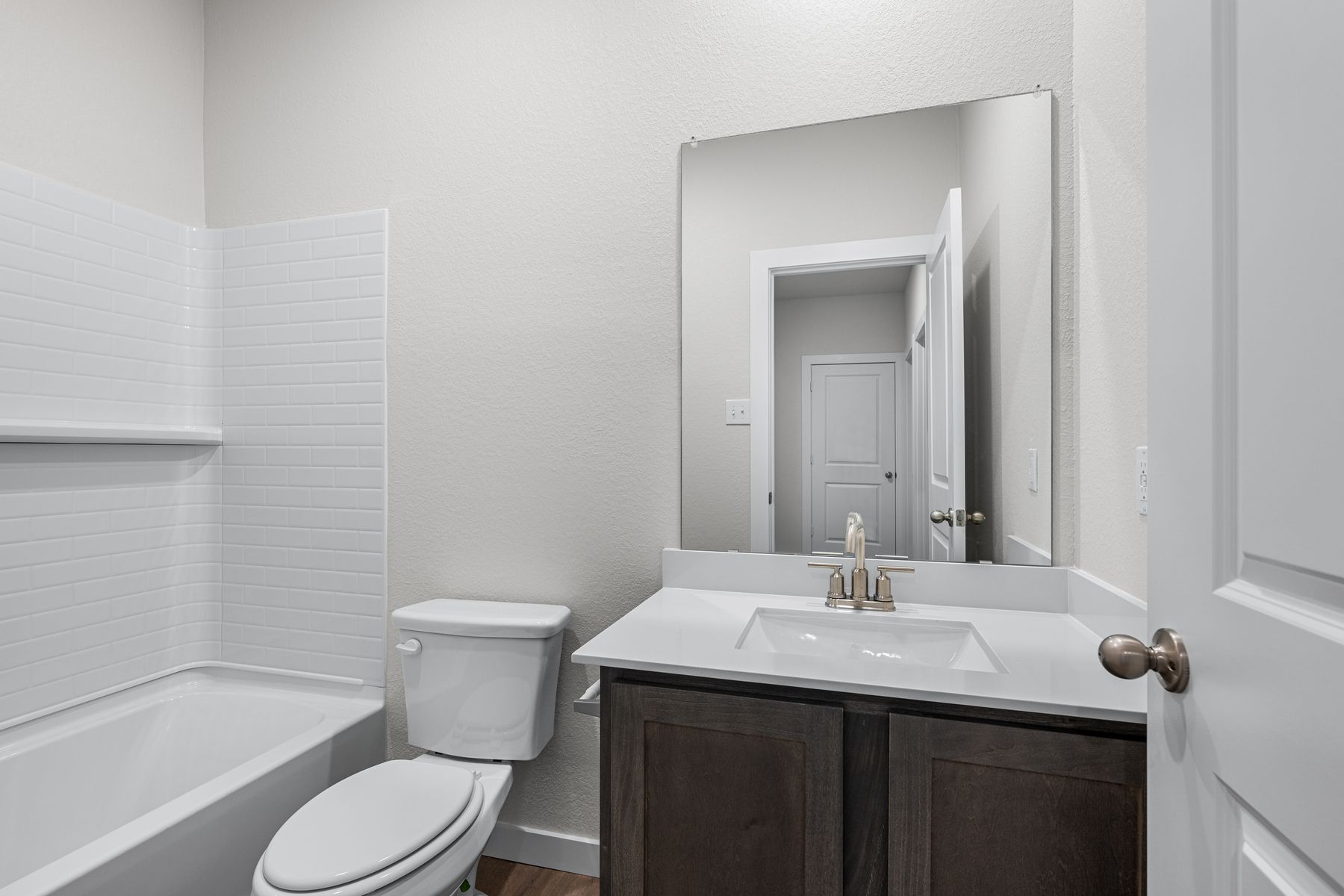 The secondary bathroom has a sprawling vanity space.