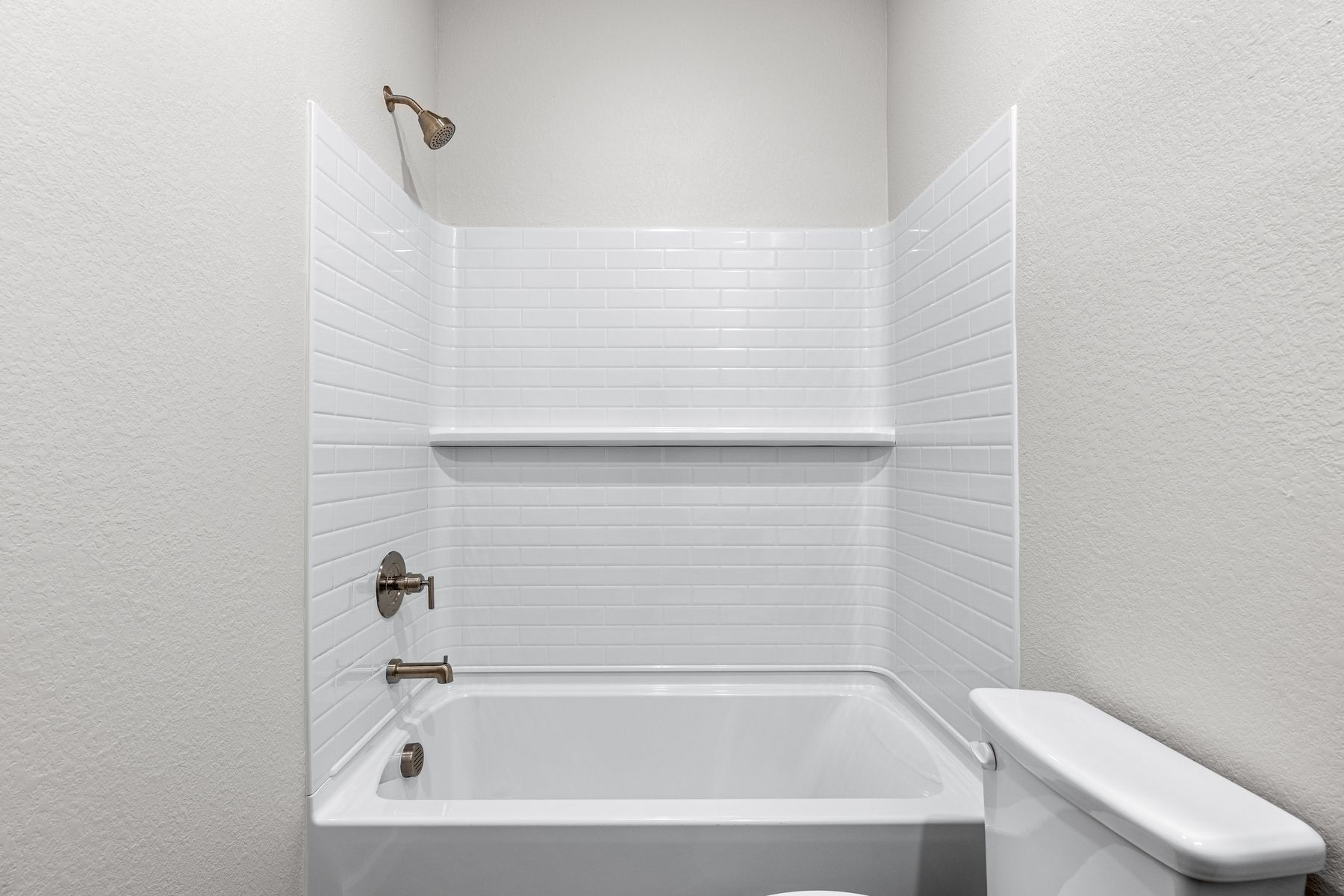The secondary bathroom has a shower-tub combo.