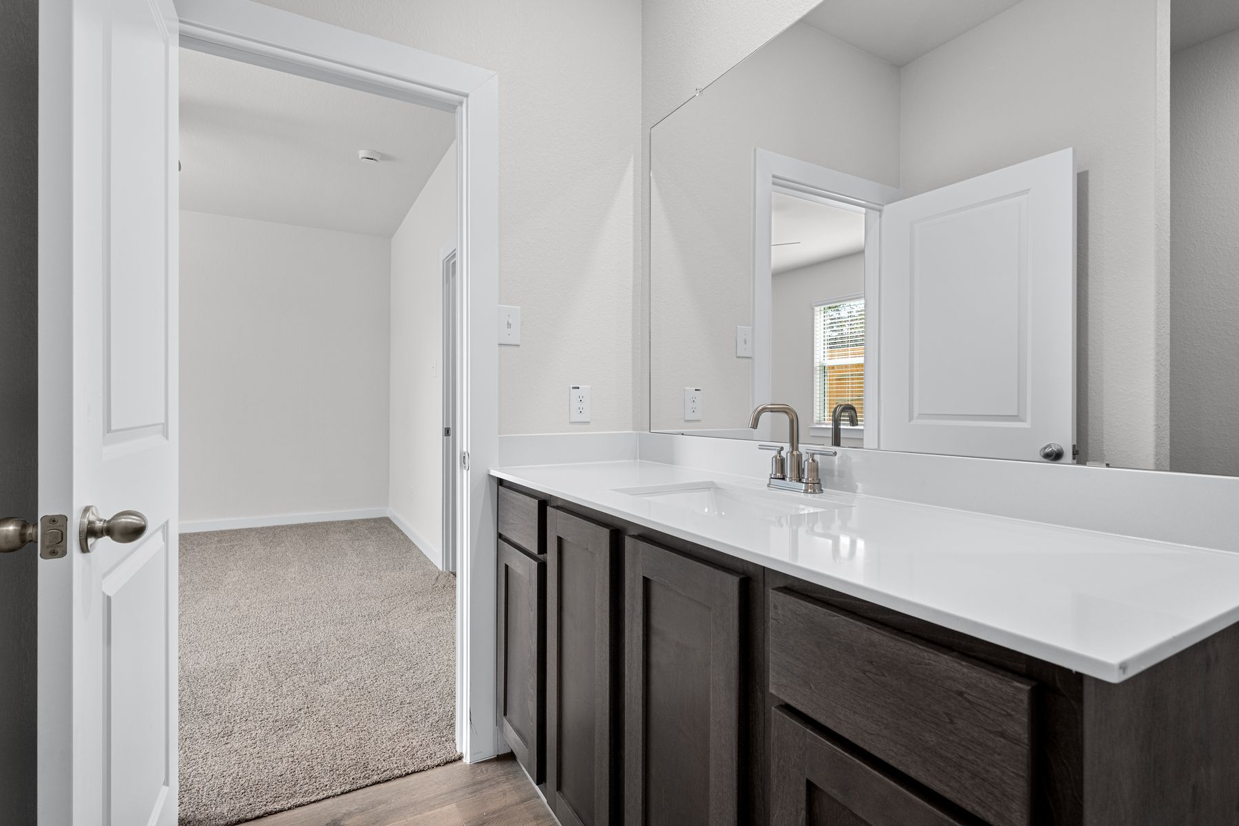 The master bathroom has a sprawling vanity.