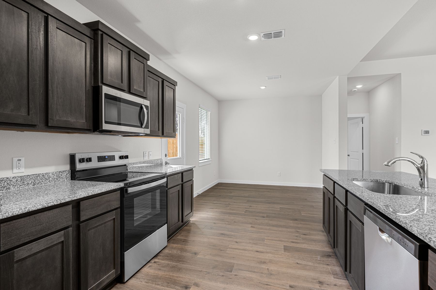 The kitchen has sprawling granite countertops.