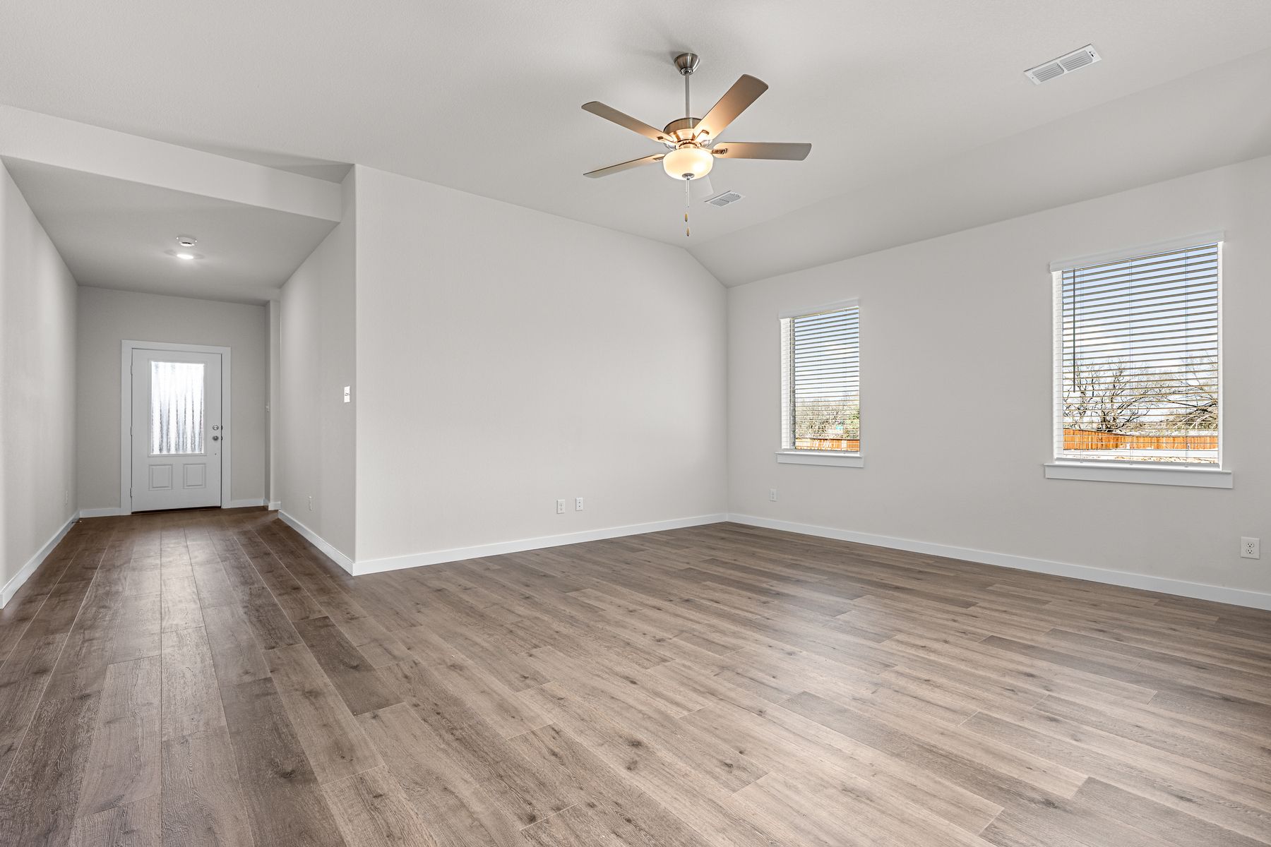 The living room has a two large windows that lets in great, natural light.