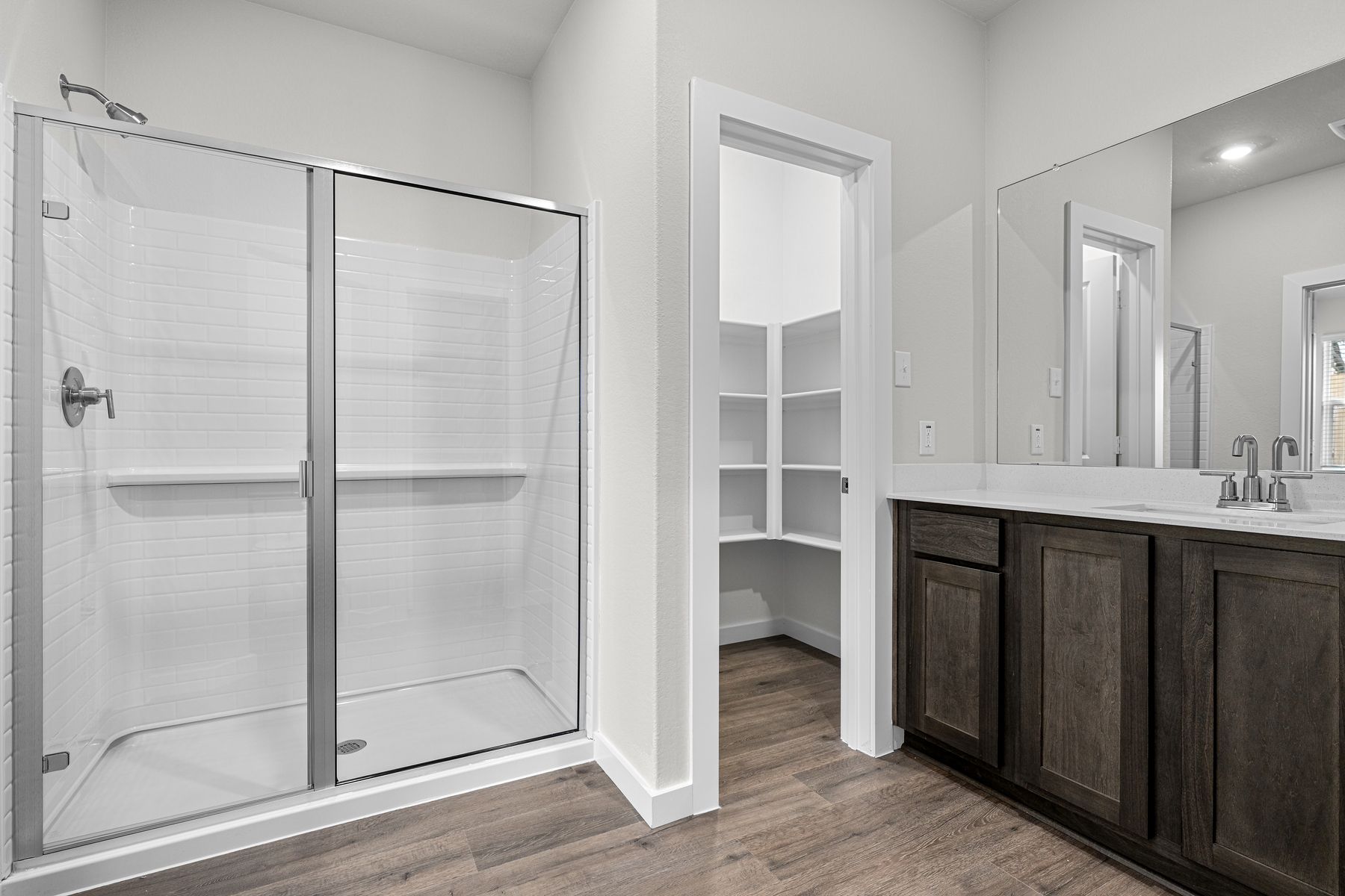 The master bathroom has a glass, walk-in shower.