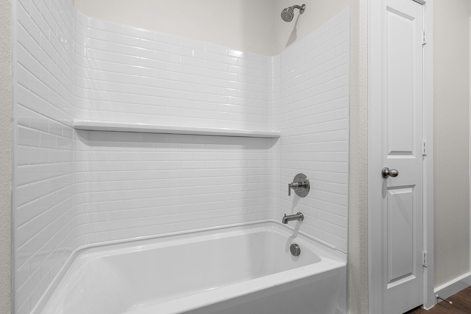 The secondary bathroom has a shower-tub combo.