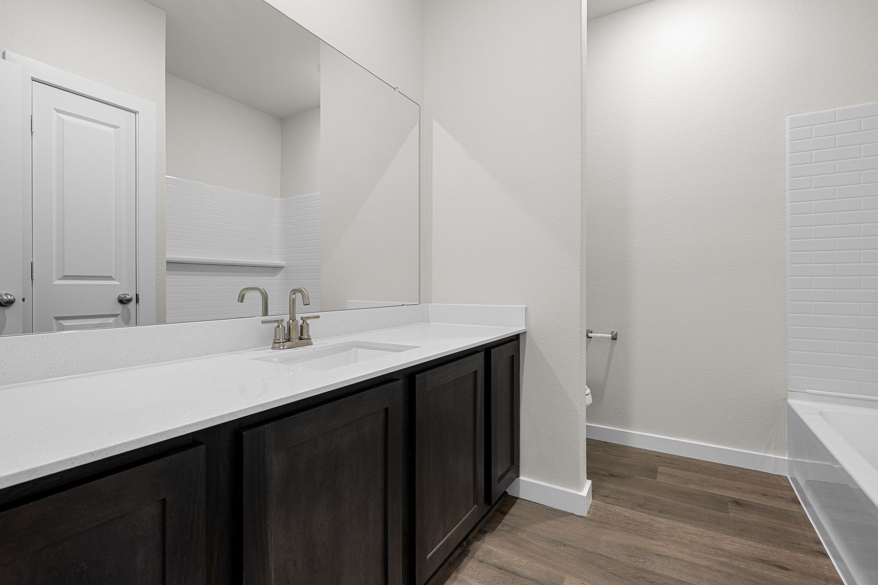 The secondary bathroom has a sprawling vanity space.