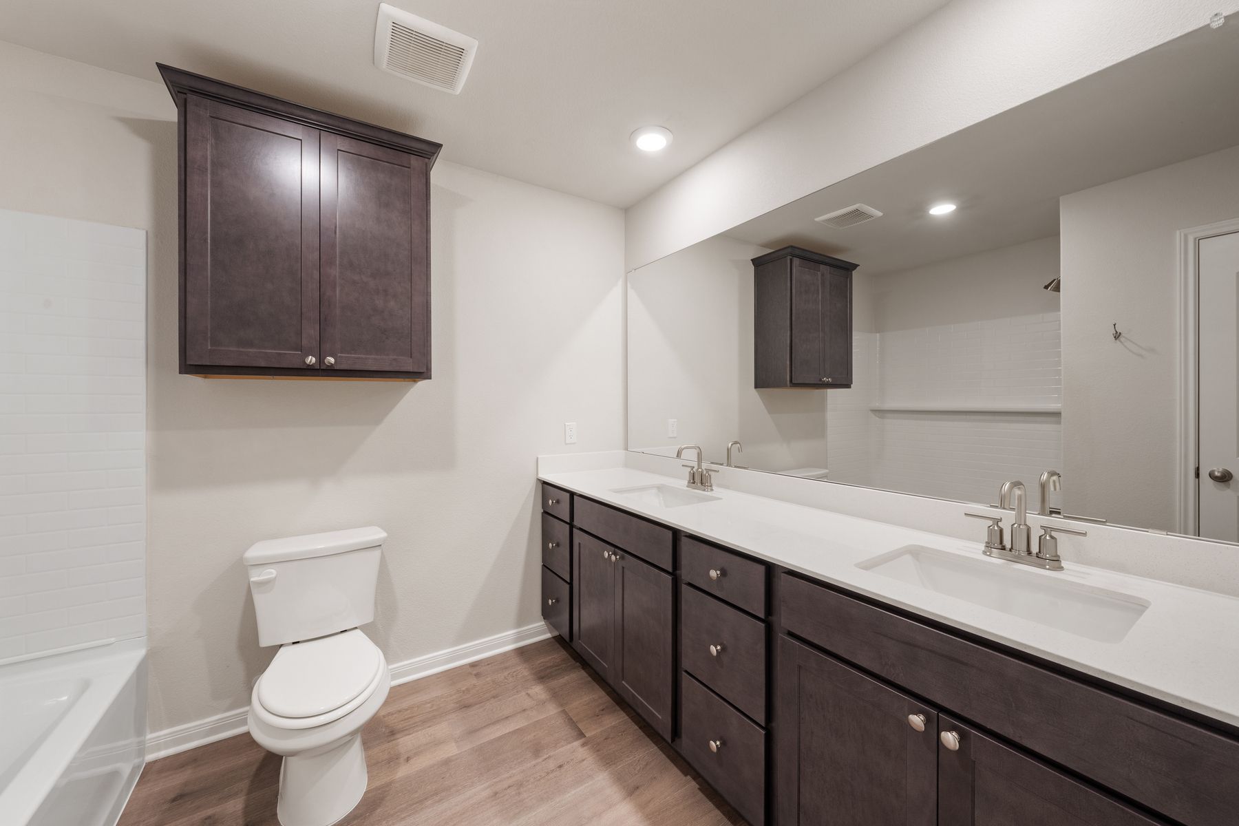 The secondary bathroom has a sprawling dual-sink vanity.