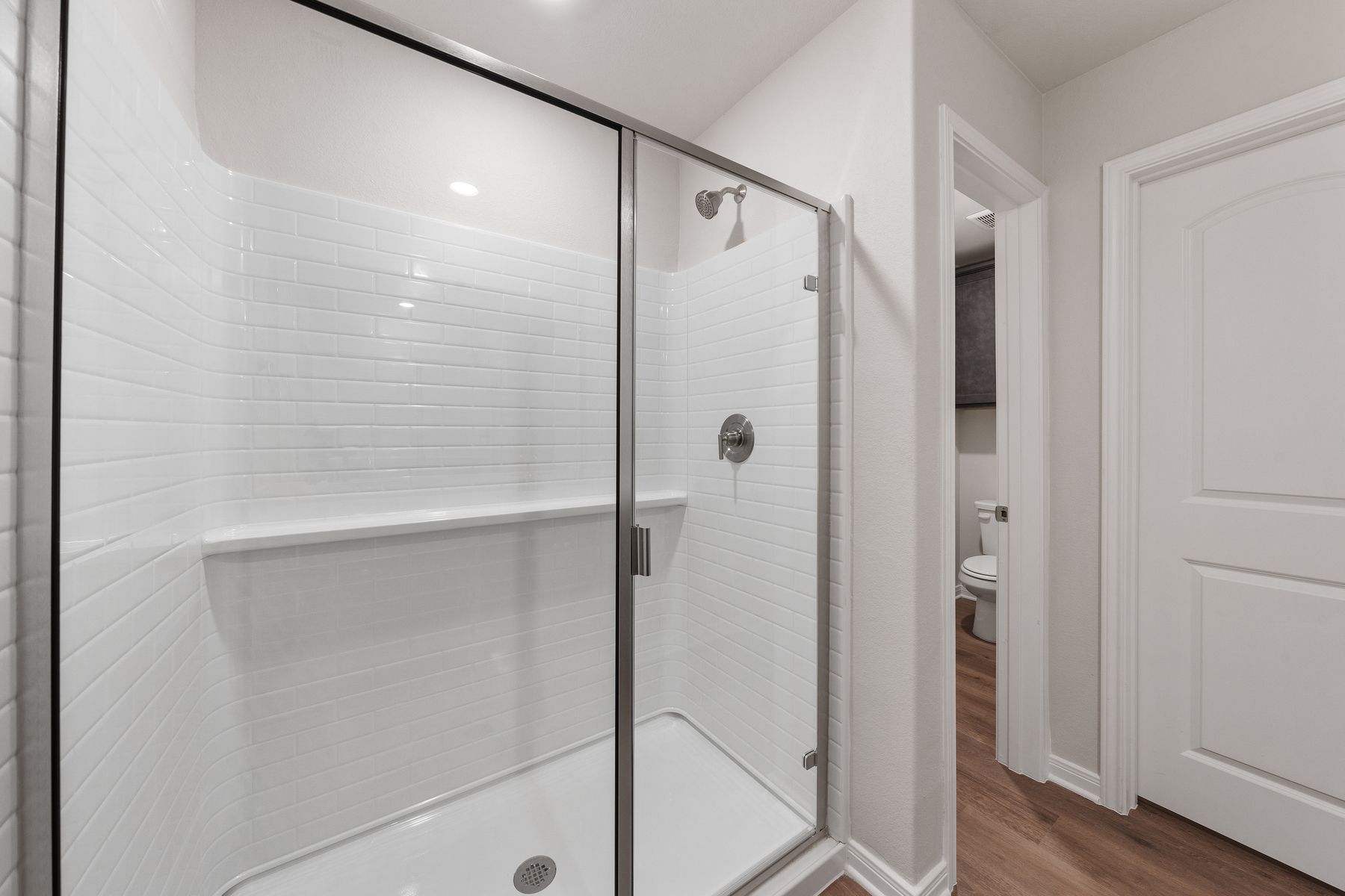 The master bathroom has a glass, walk-in shower. 