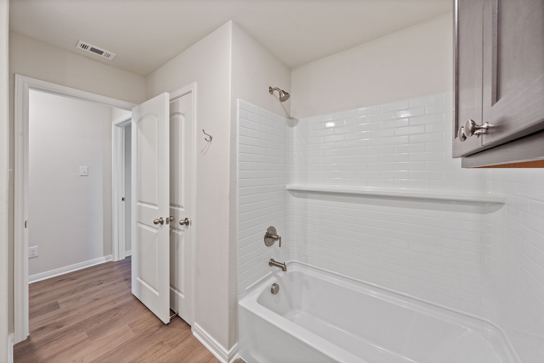 The secondary bathroom has a shower-tub combo.