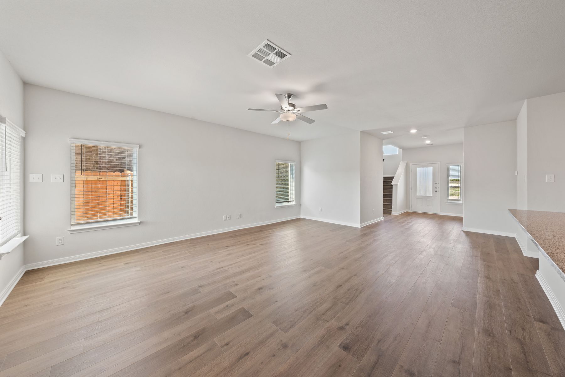The kitchen, dining room, and living room all sit adjacent to one another.