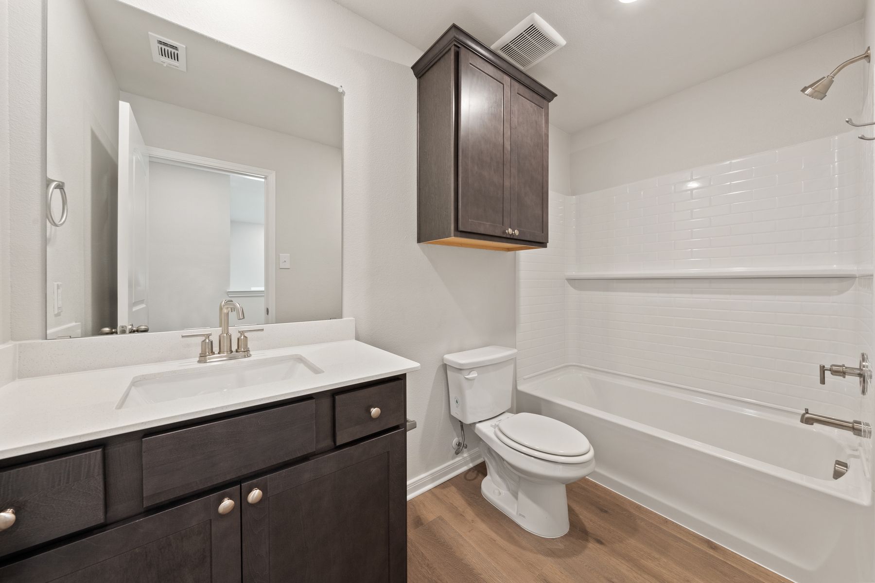 The secondary bathroom has a wonderful vanity and shower-tub combo.
