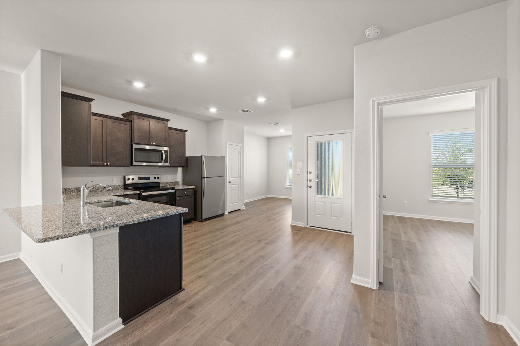 The kitchen and dining room sit right next to each other. 