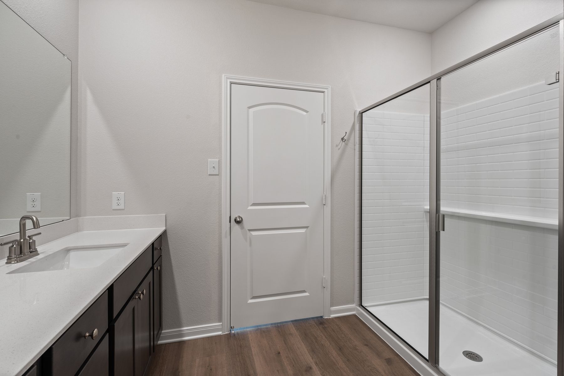 The master bathroom has a glass, walk-in shower.