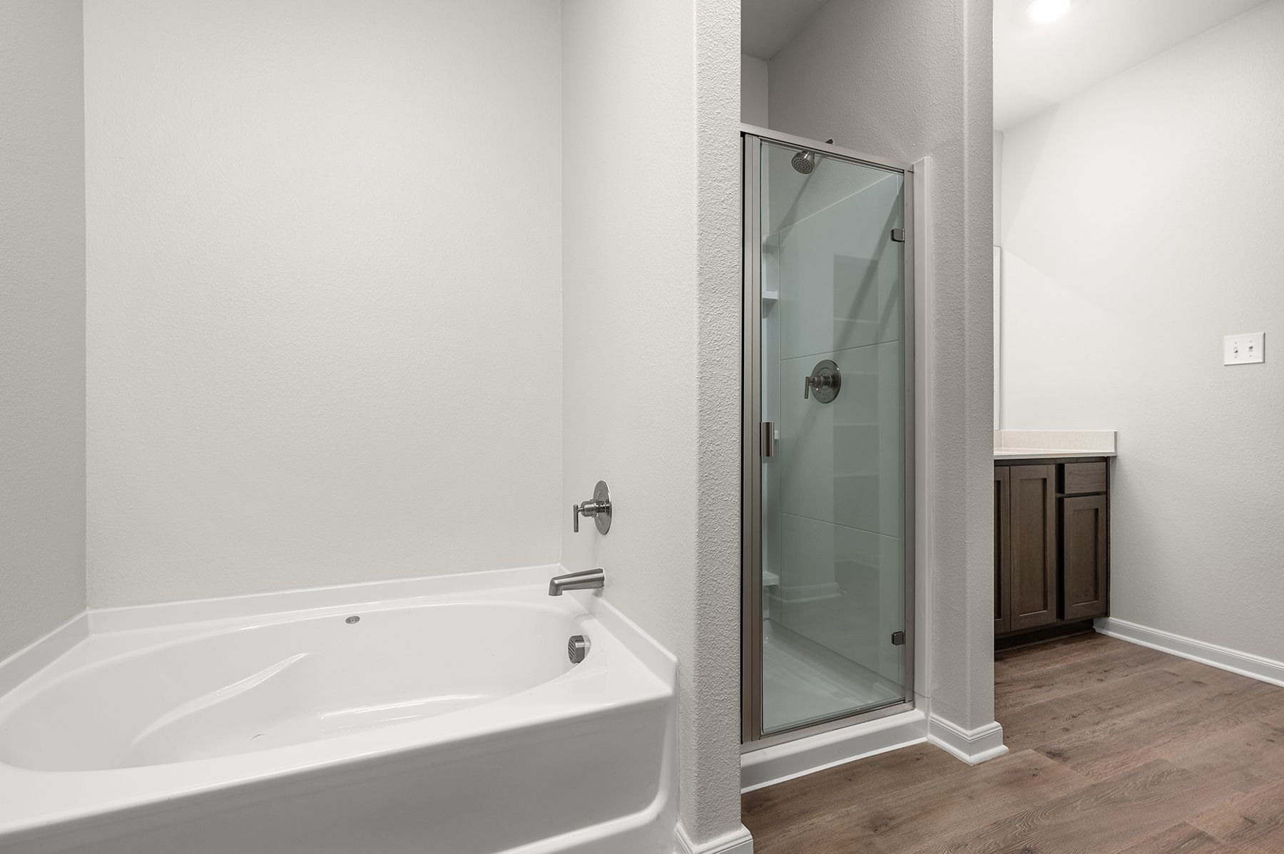 The master bathroom has a garden tub and glass walk-in shower..