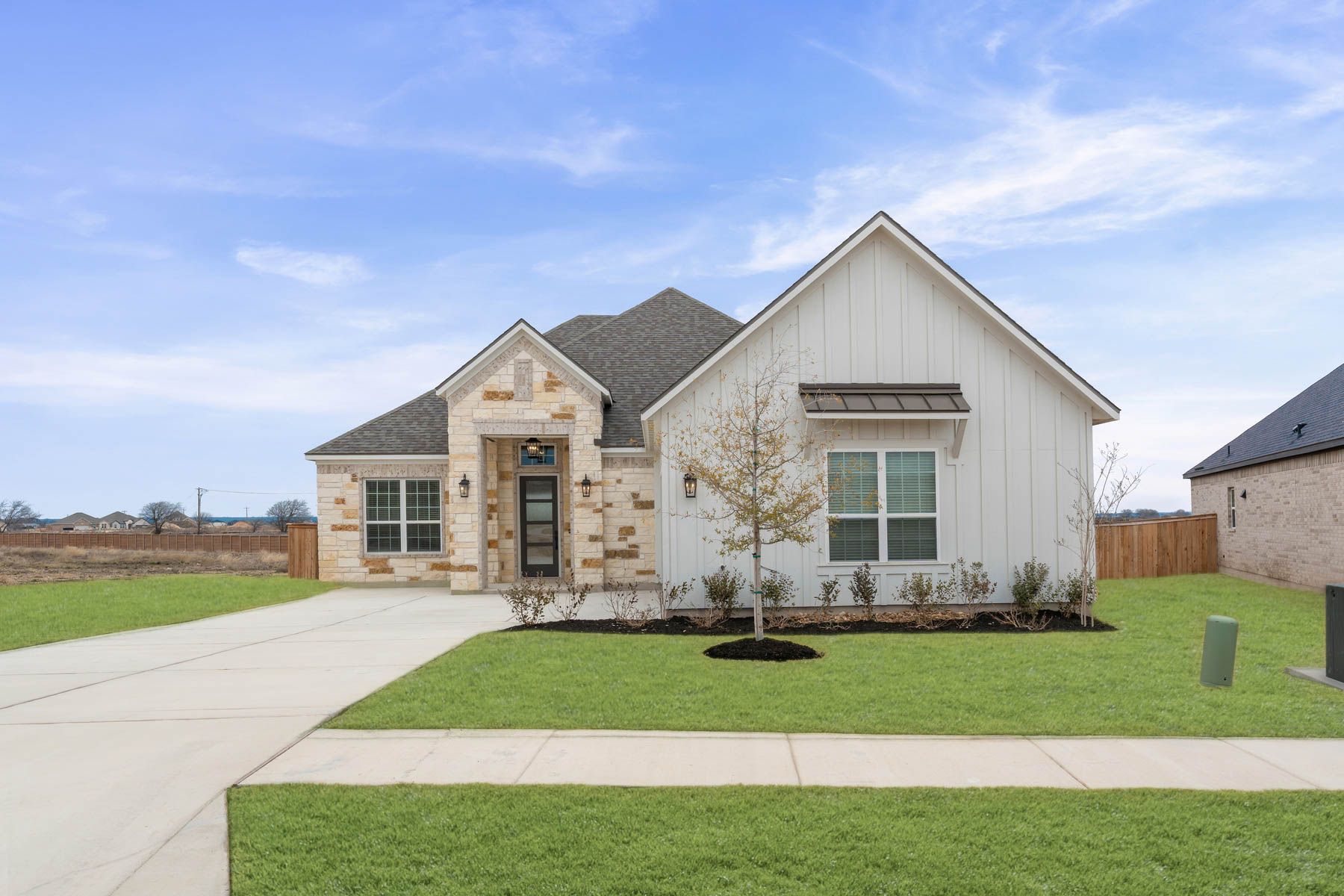 The Kingsley is a beautiful one-story home with stone and siding exterior.