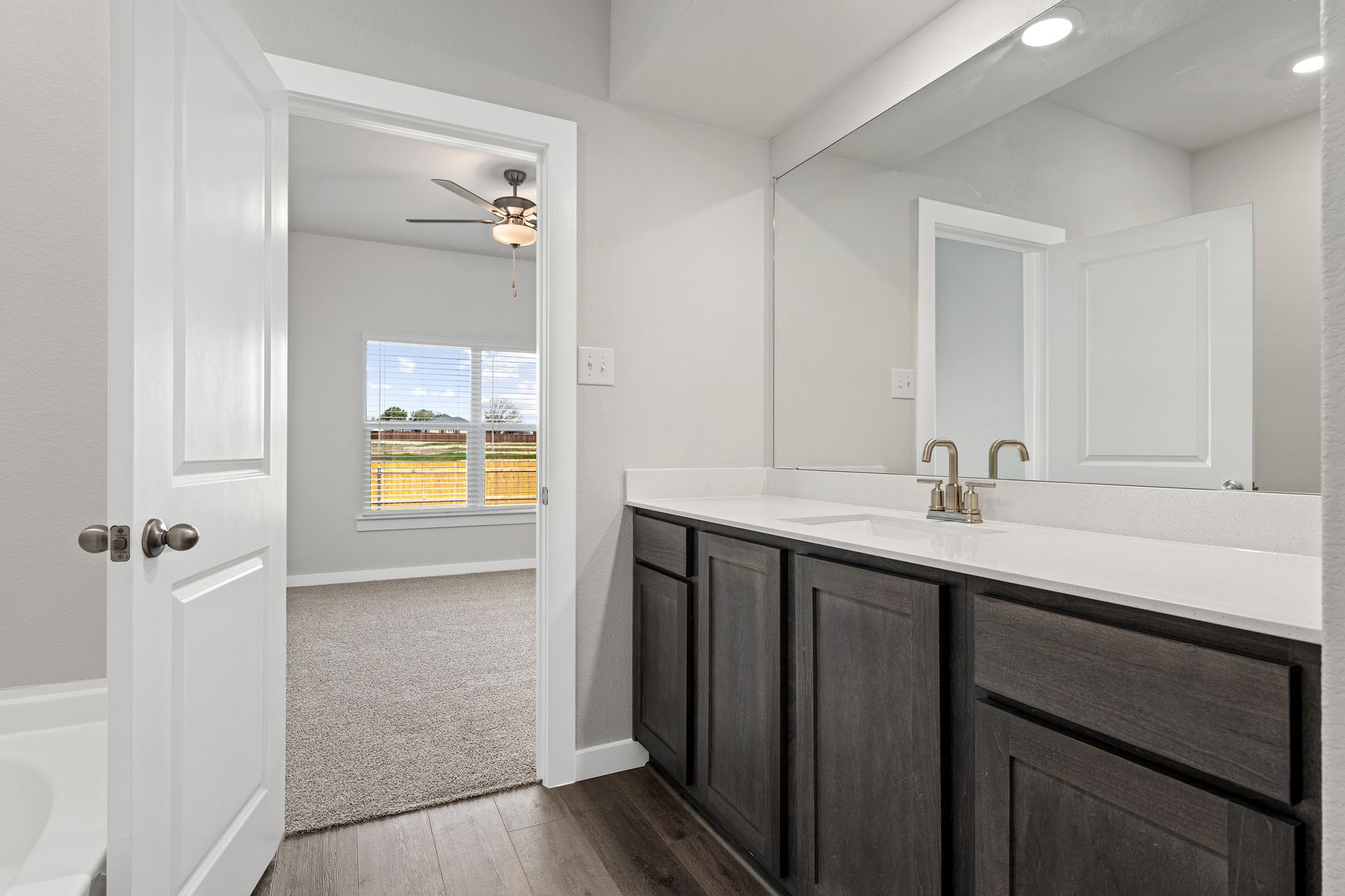 The master bathroom has a sprawling vanity.