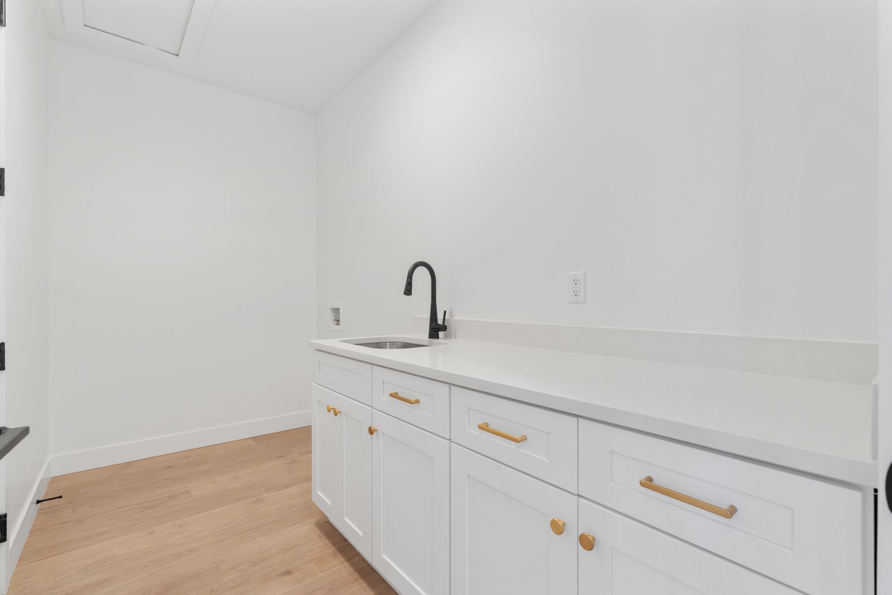 The spacious laundry room with additional sink. 