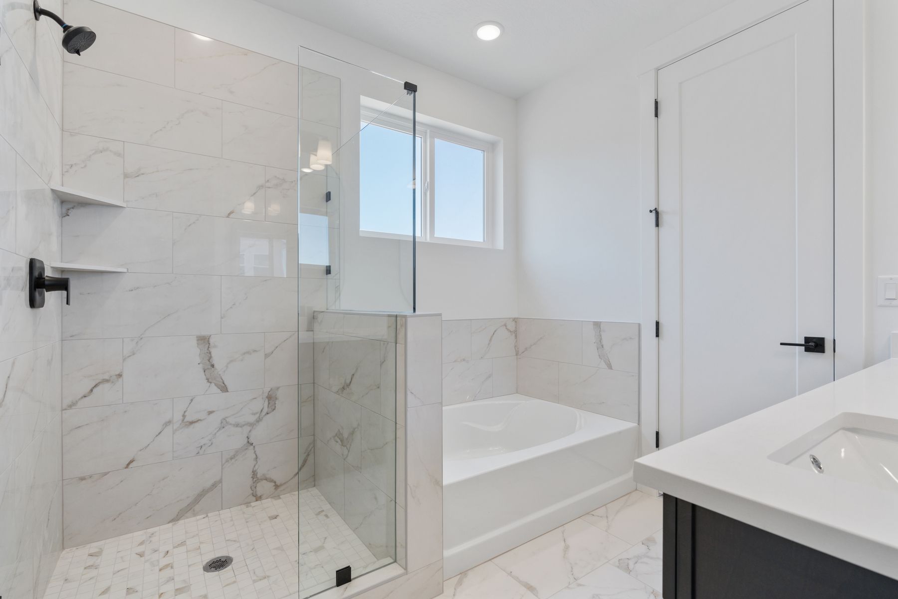 The master bathroom has a glass, walk-in shower and garden tub. 