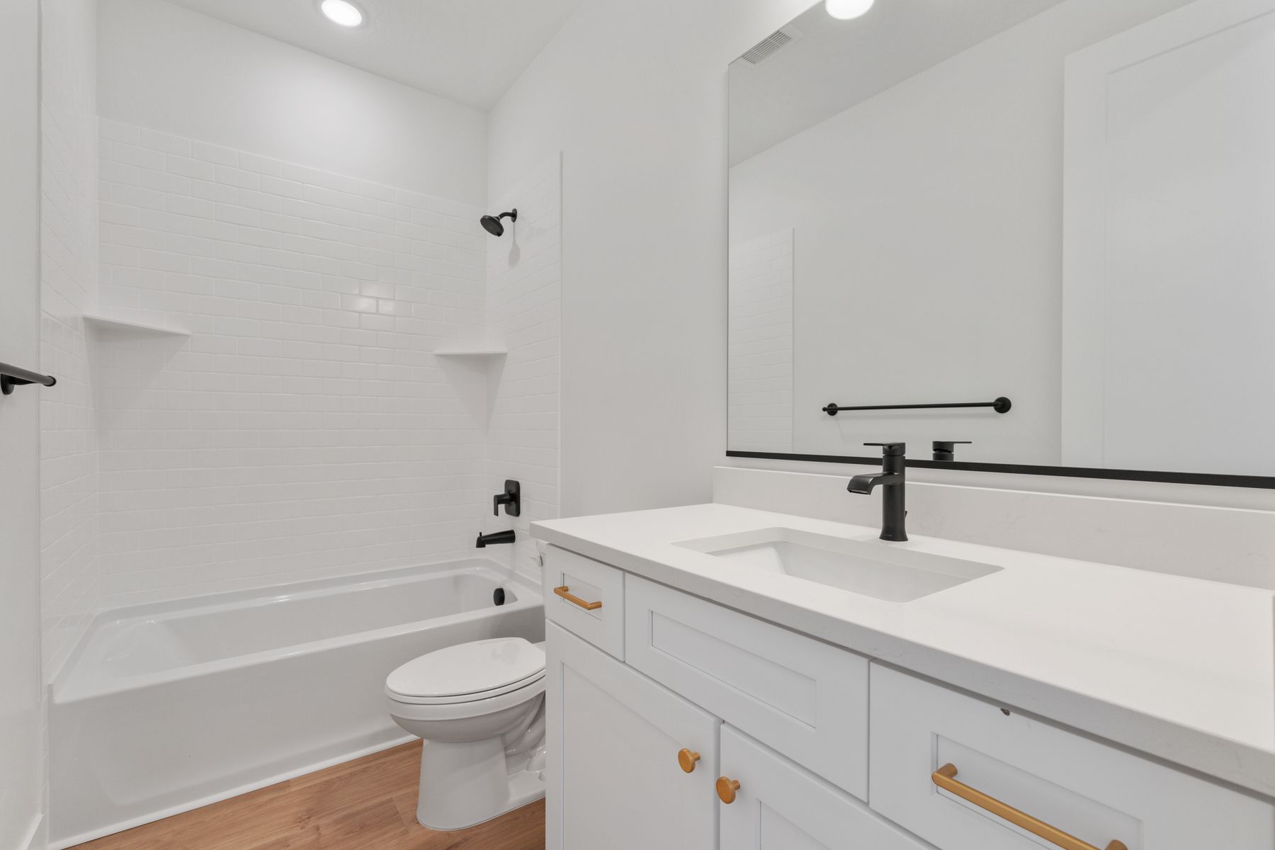 The secondary bathroom with ample countersapce and beautiful shower tub.
