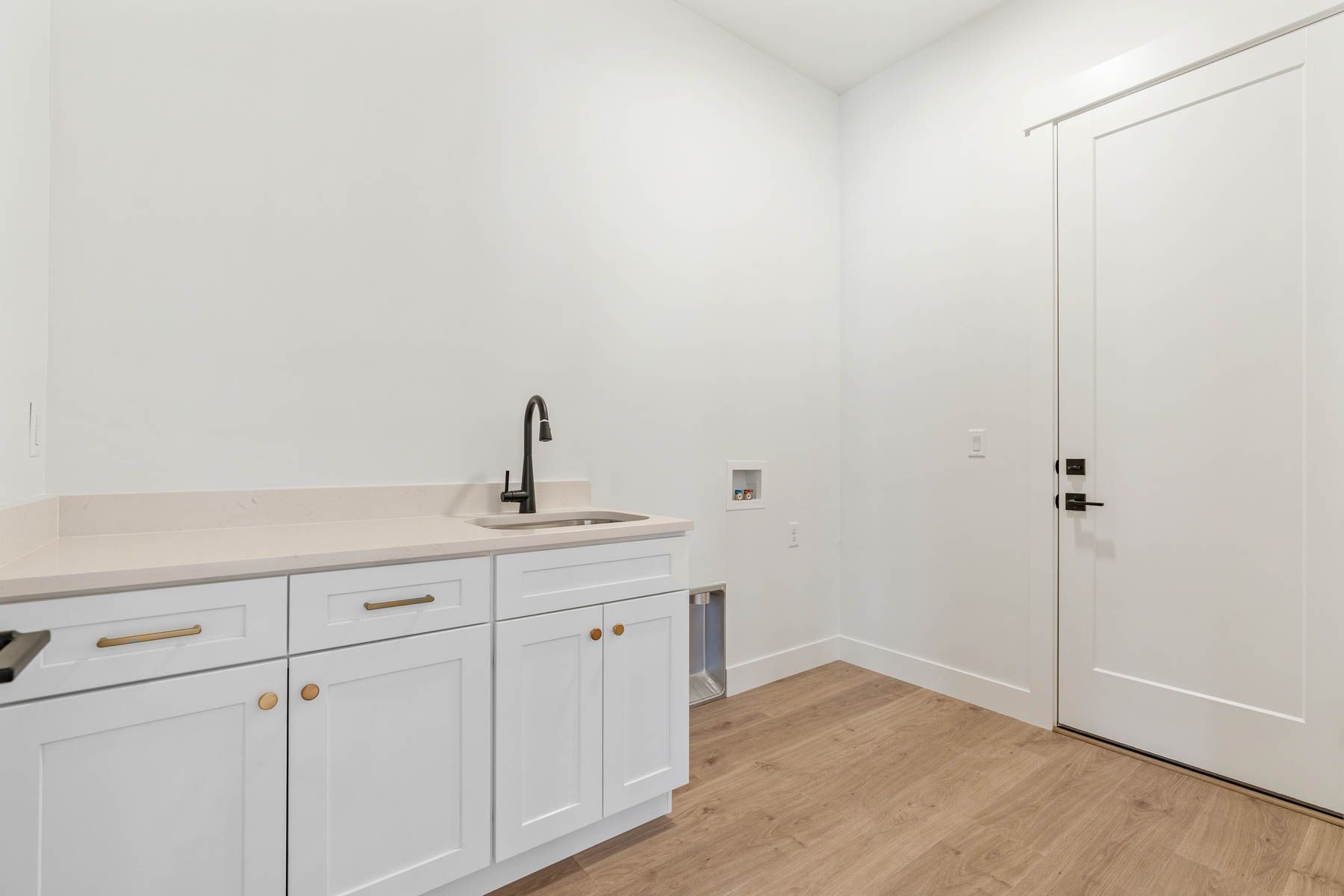 This home boasts a spacious laundry room feauturing a sink.